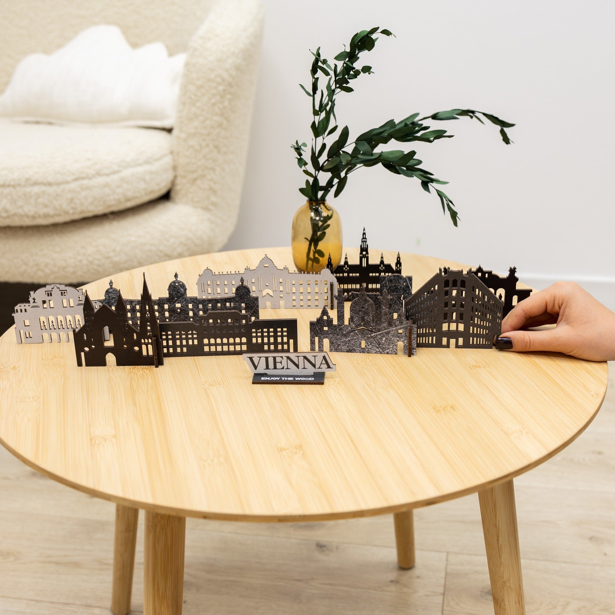 Model of Vienna on a wooden table with a hand interacting with it