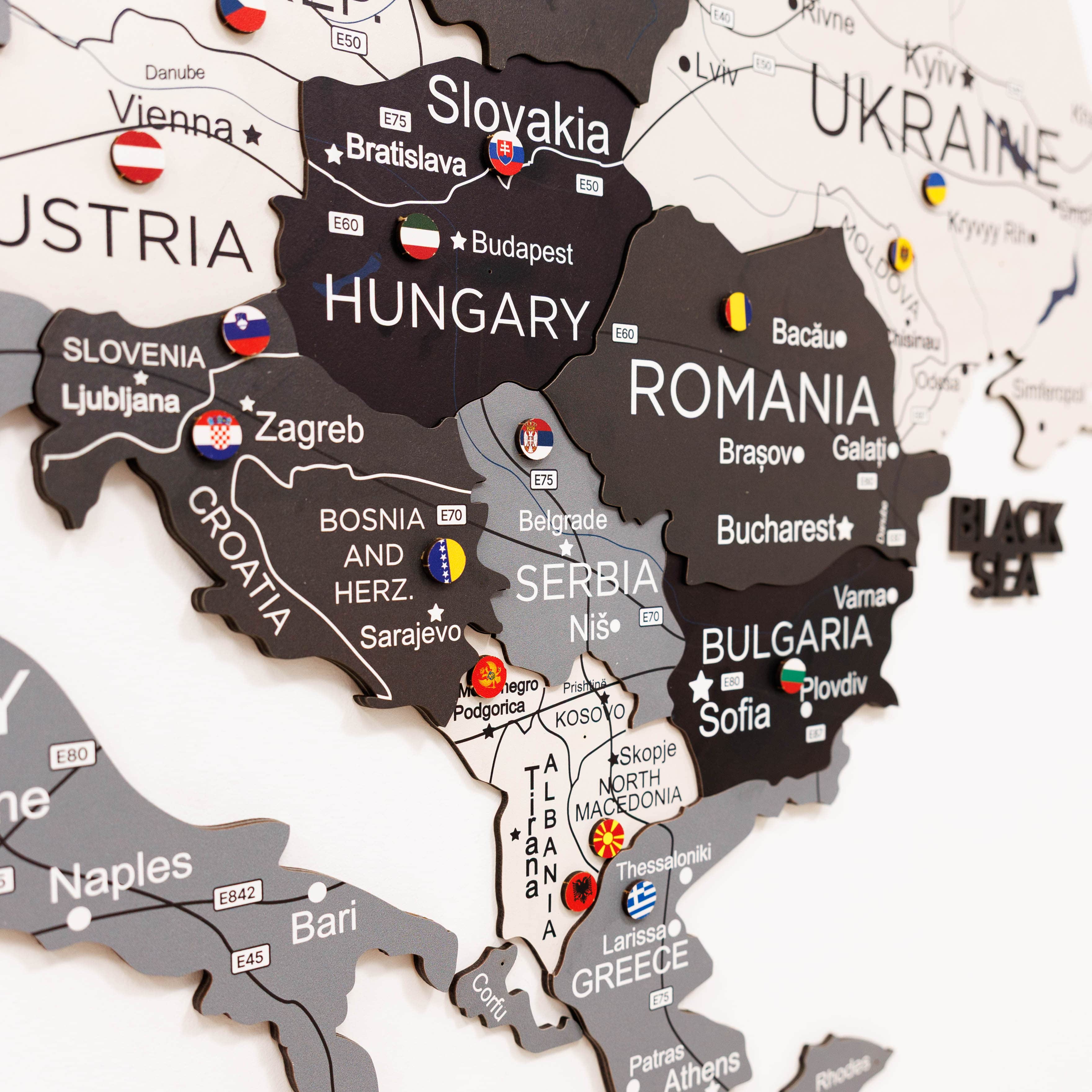 Woman interacting with a map of Europe on a wall, highlighting Poland.