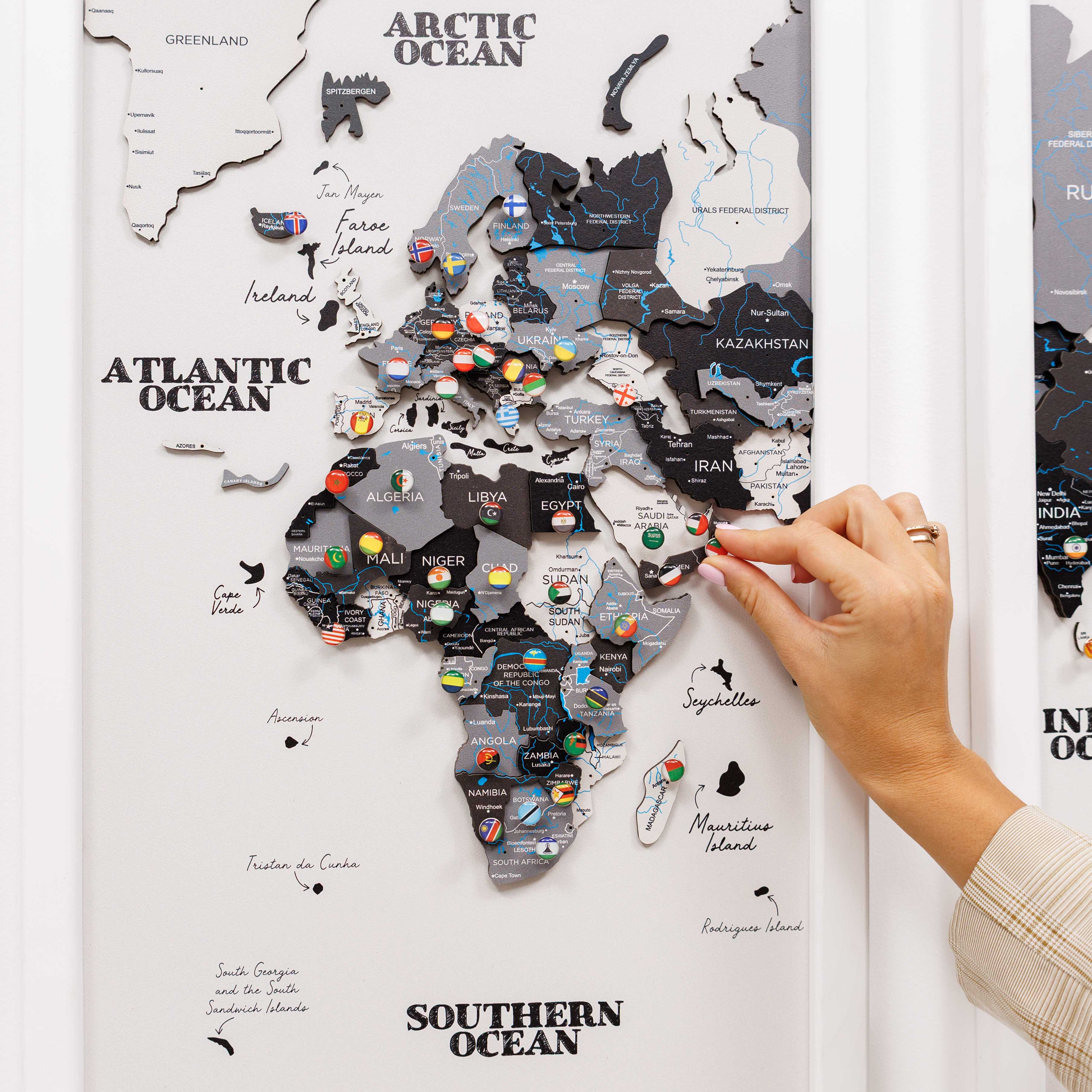Map of Africa with pins attached, hand interacting with the map