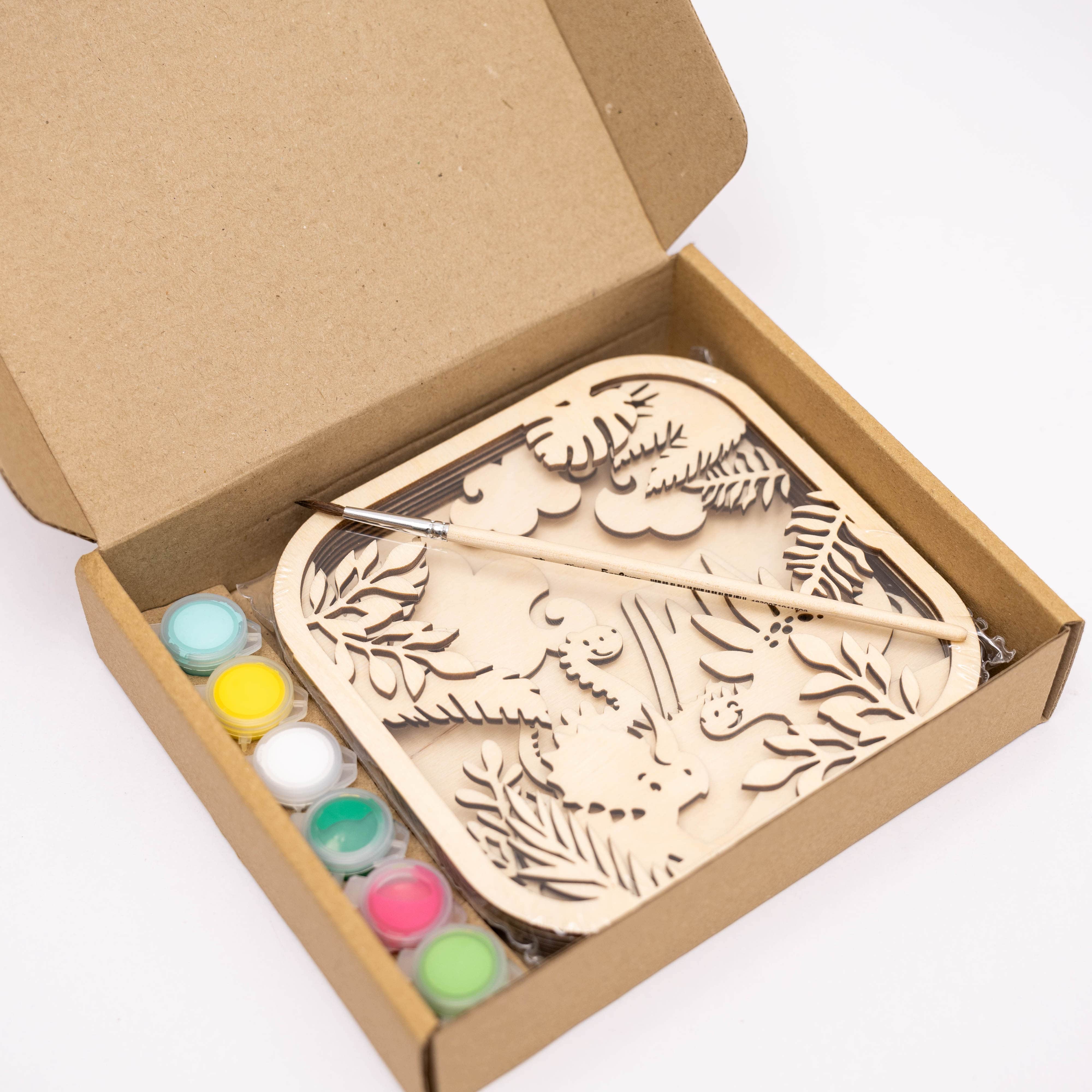 Wooden embossing tool set with paint colors in a cardboard box on a white background