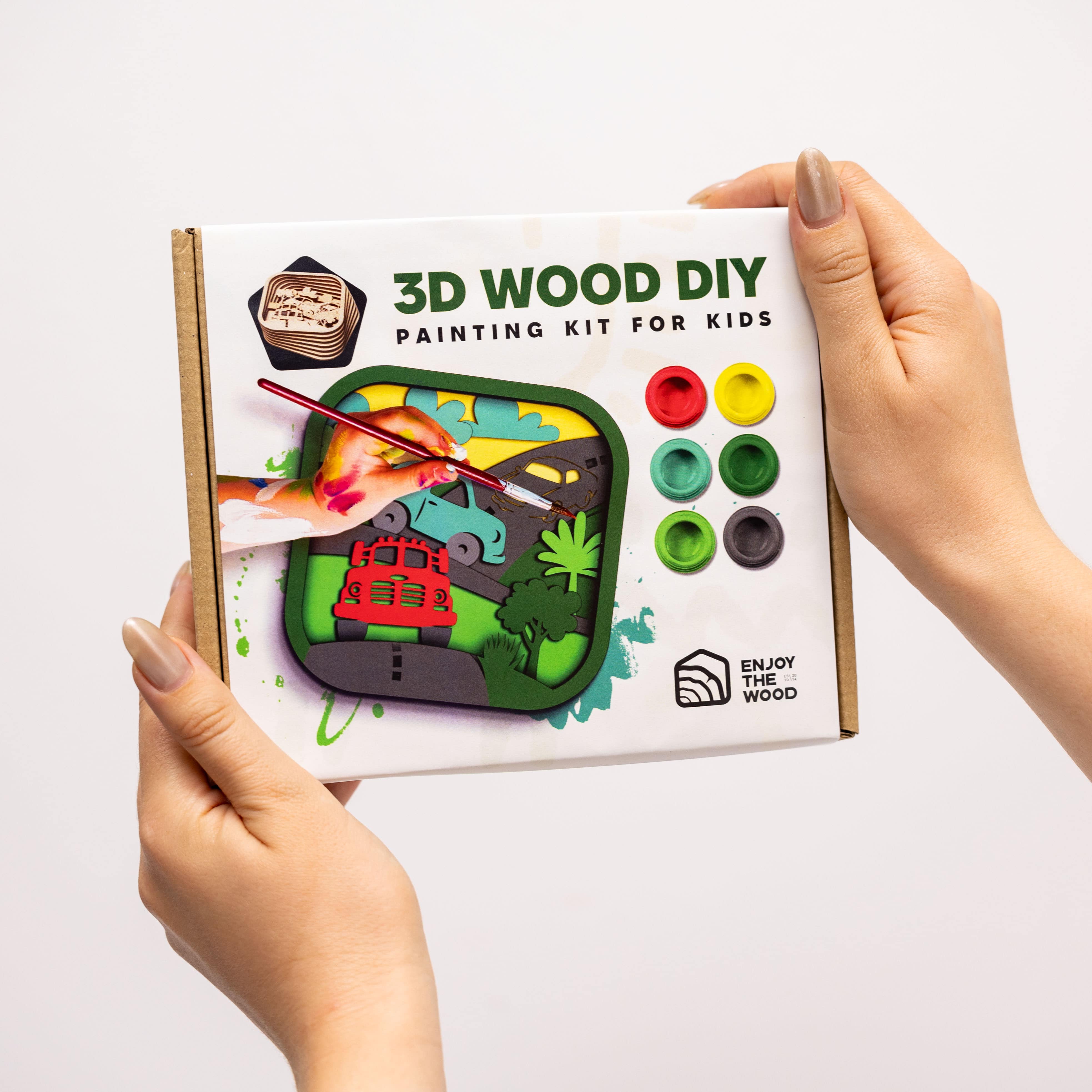 3D Wood DIY painting kit for kids held by a person on a white background