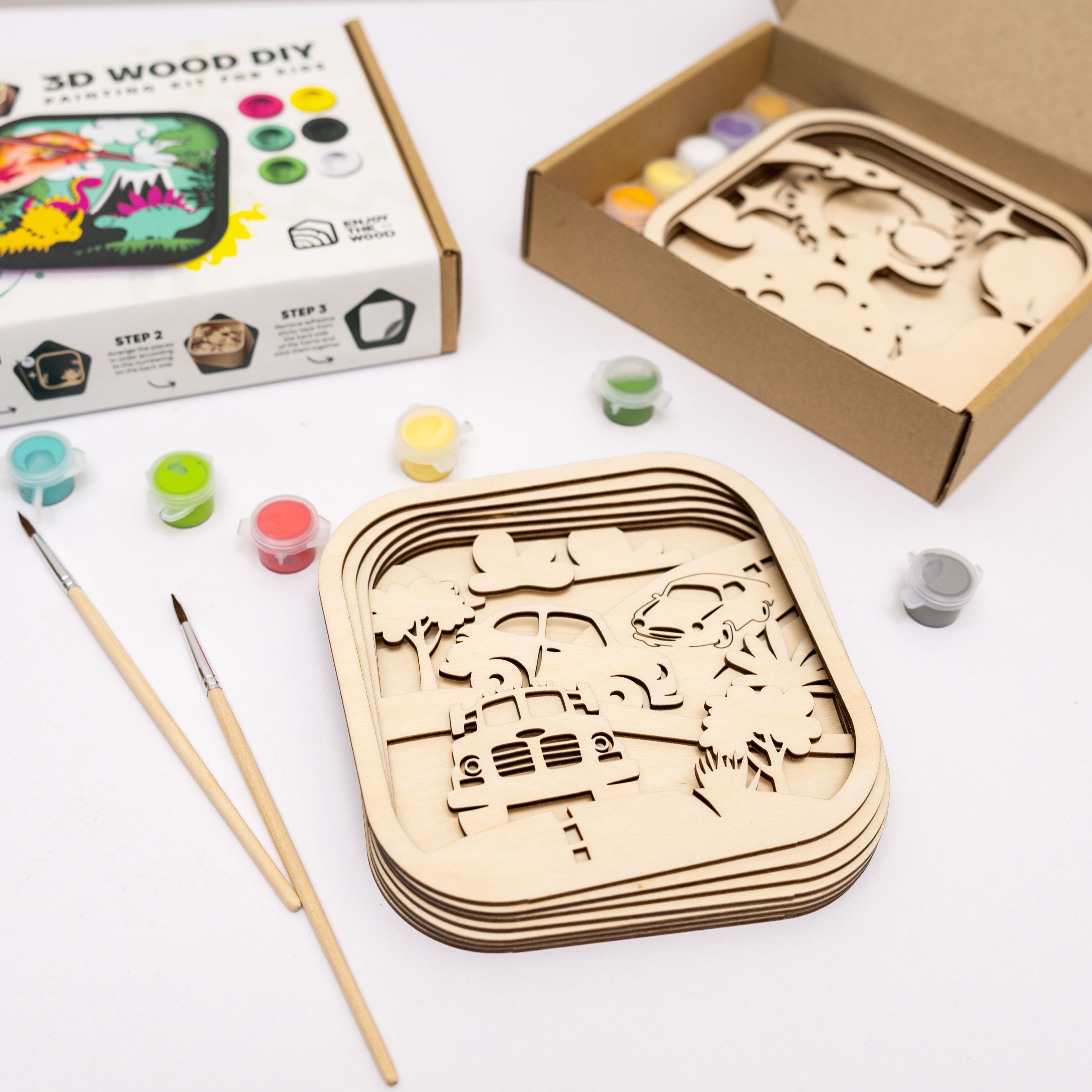 Wooden 3D puzzle with paint supplies on a white surface