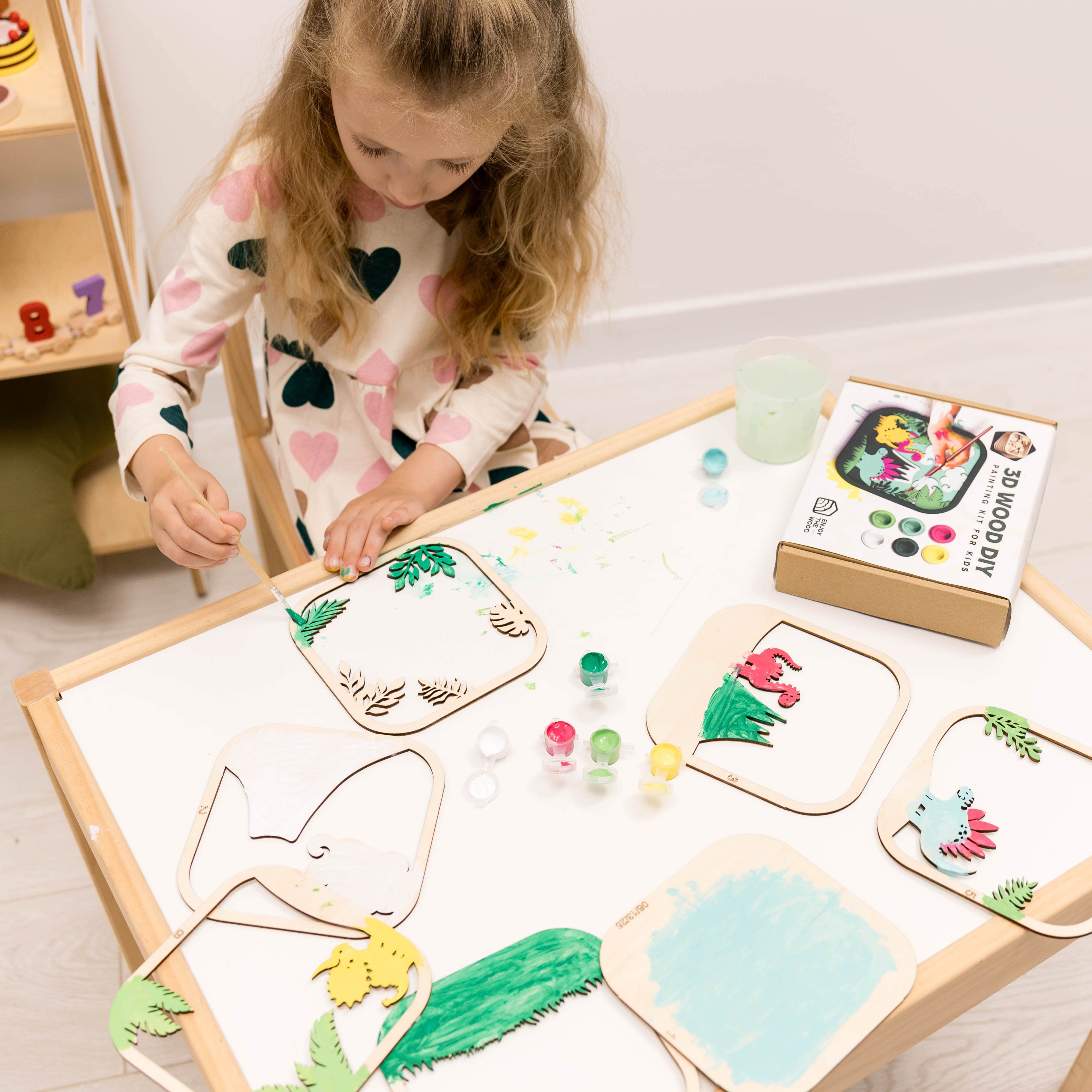 Child playing with a creative art set on a table
