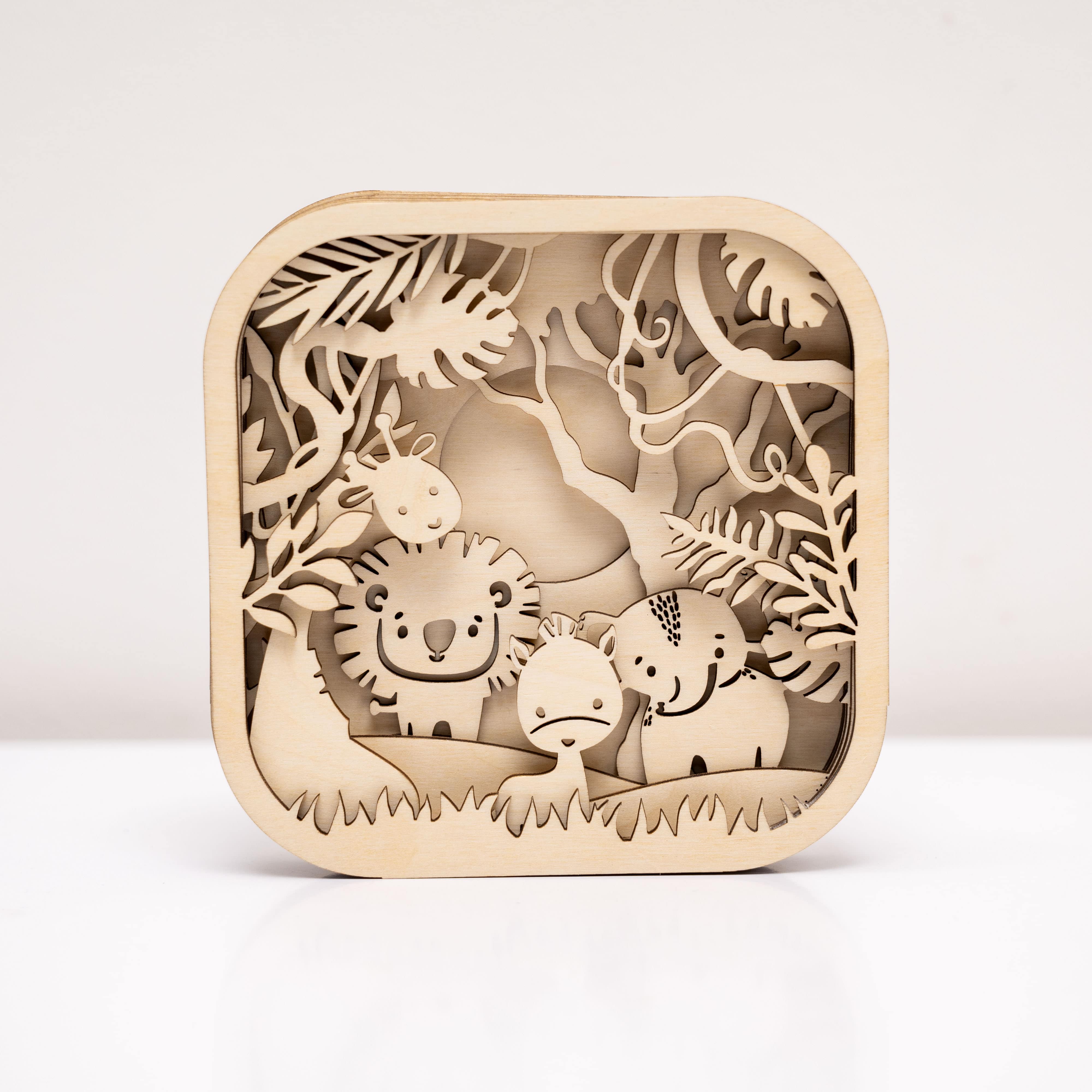 Wooden cut-out design of animals in a forest on a white background