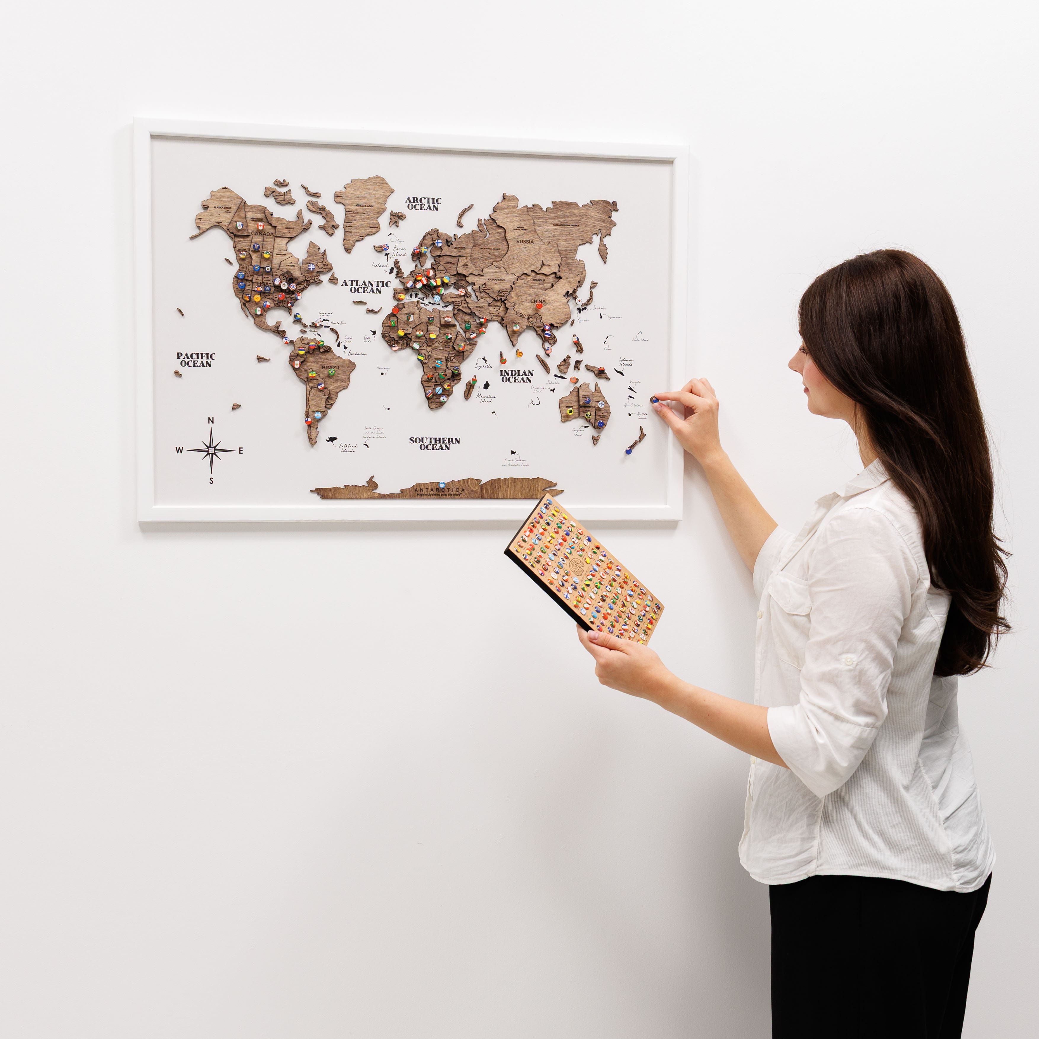 Woman interacting with a world map on a wall