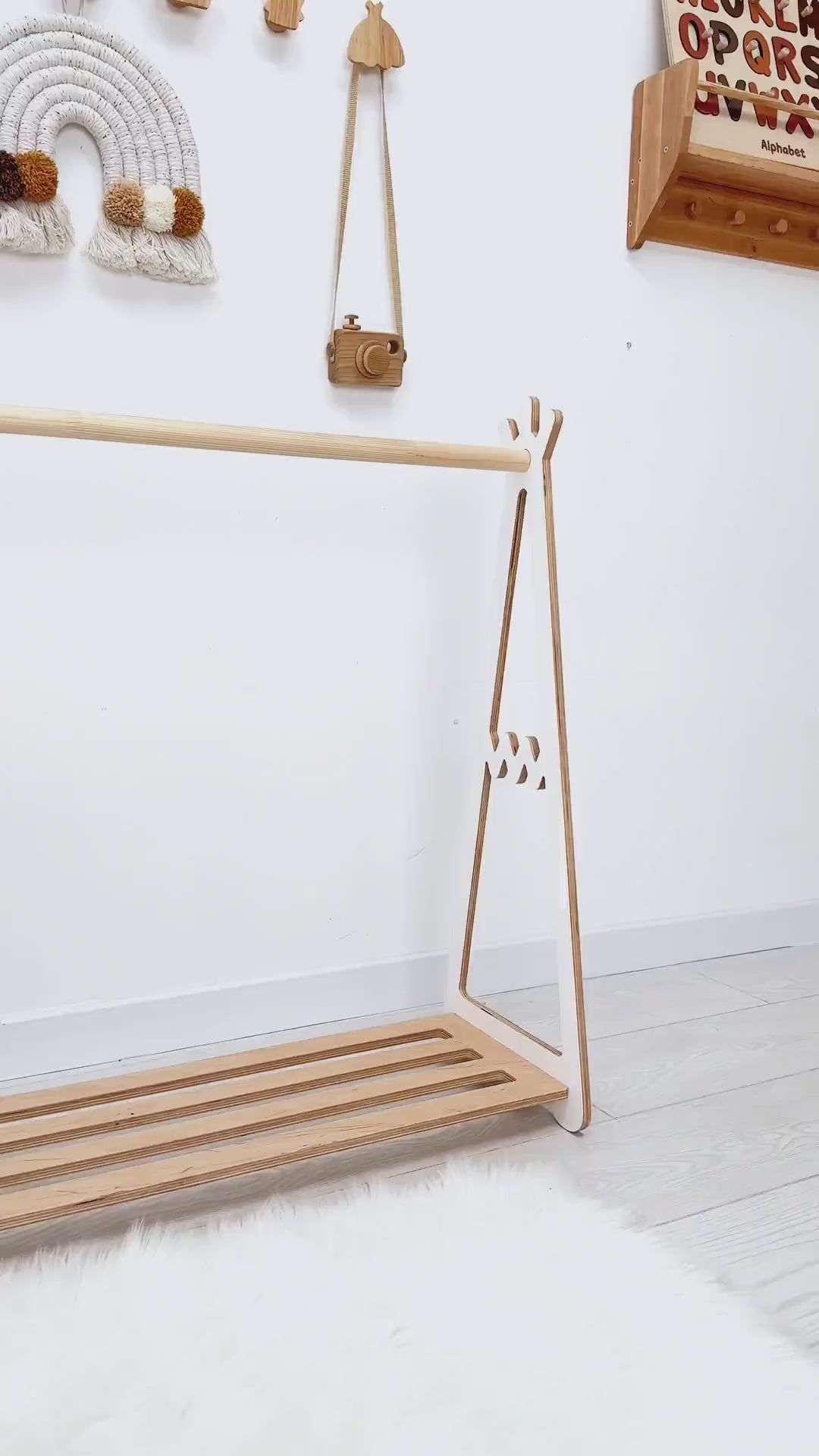 Wooden Montessori kids clothing rack with bottom shelf, minimalist open wardrobe for nursery.
