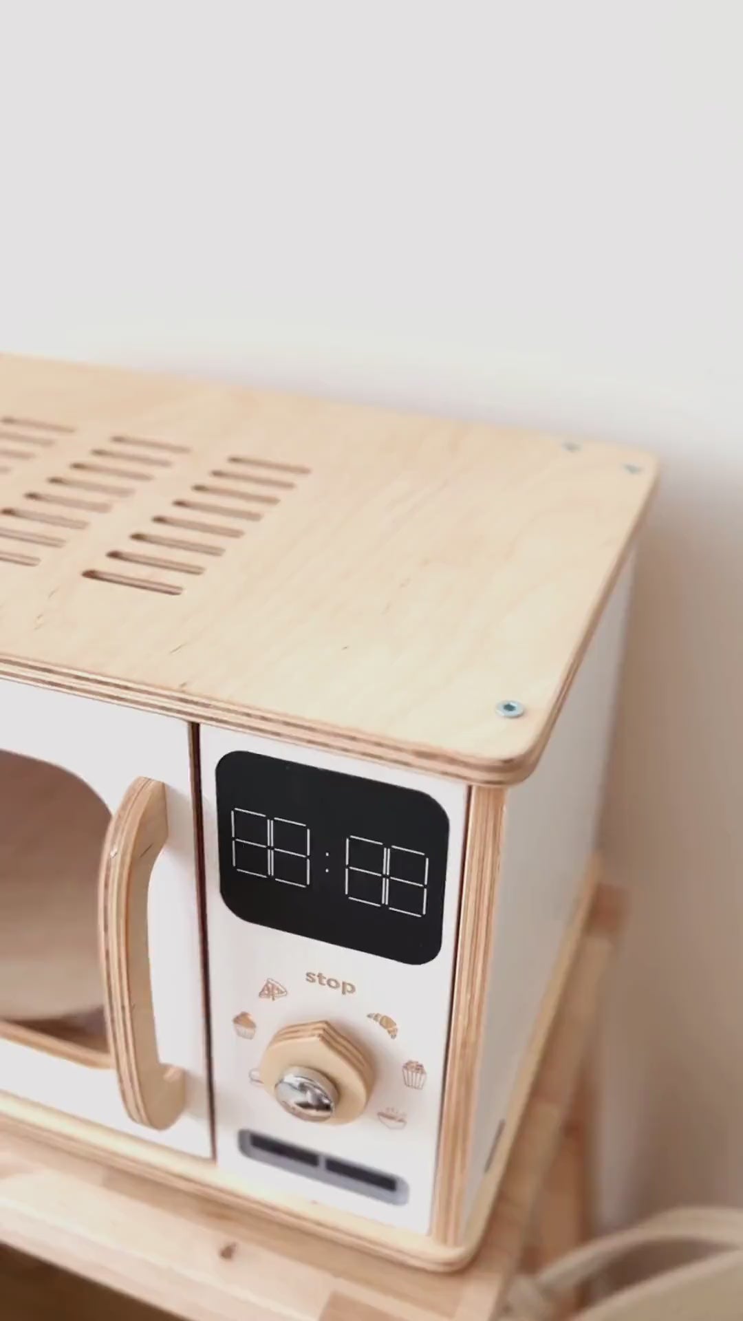 Eco-friendly wooden toy microwave for pretend play.