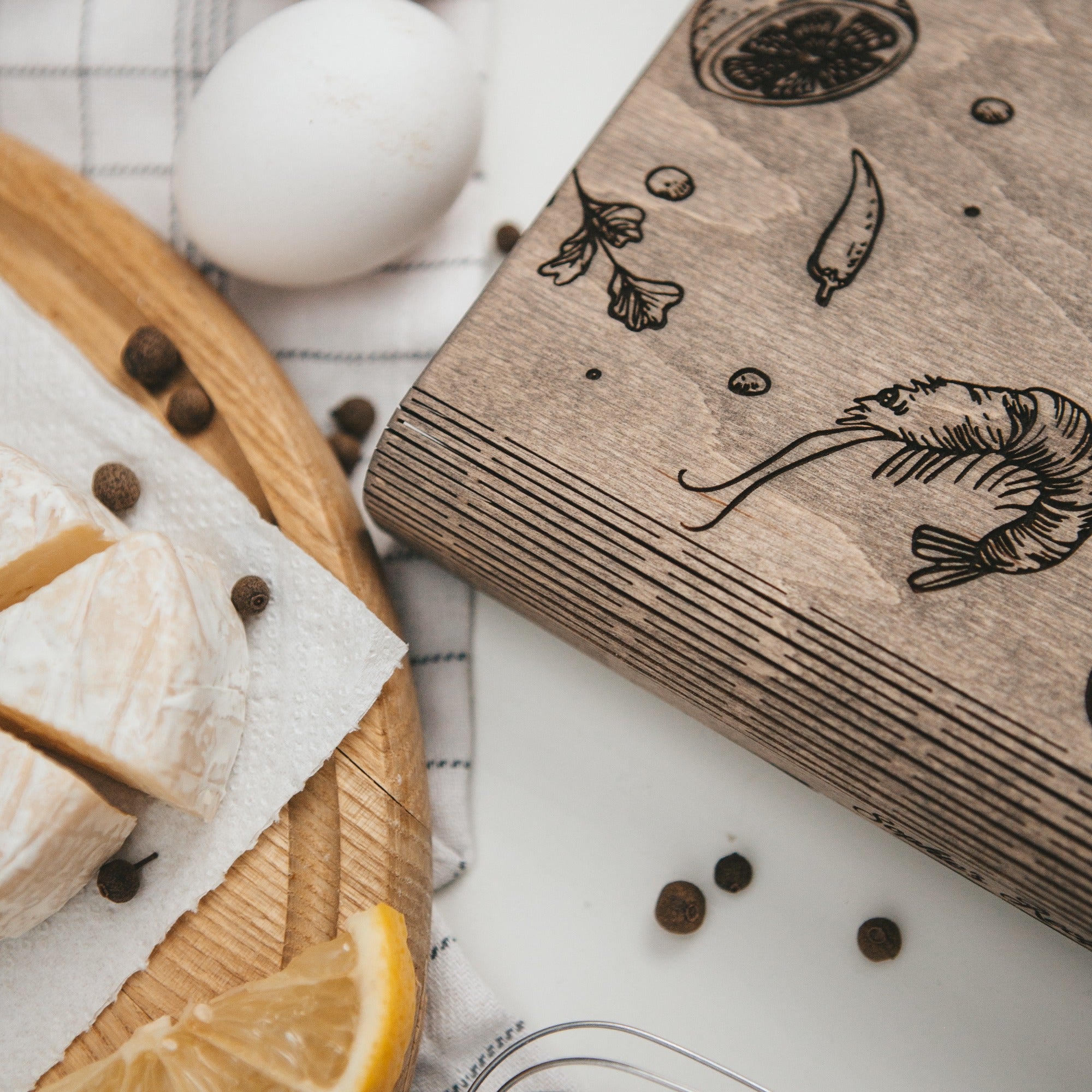 Wooden block with engraved designs on a table with food items