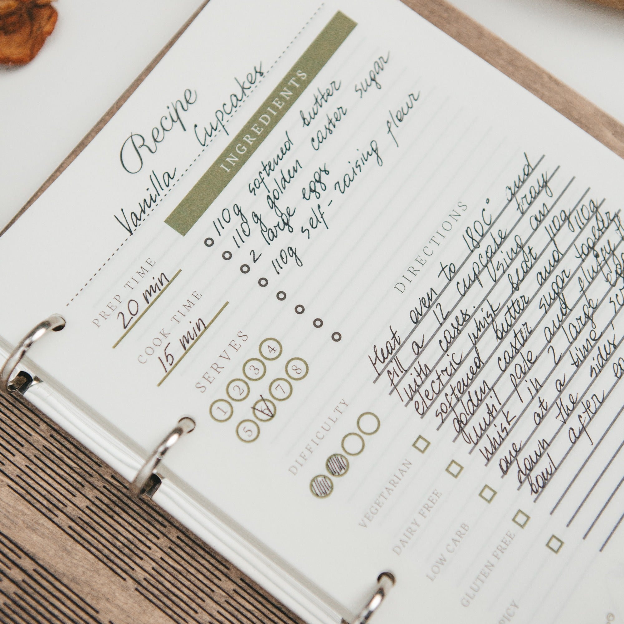 Recipe book open to a vanilla cupcake recipe with handwritten notes.