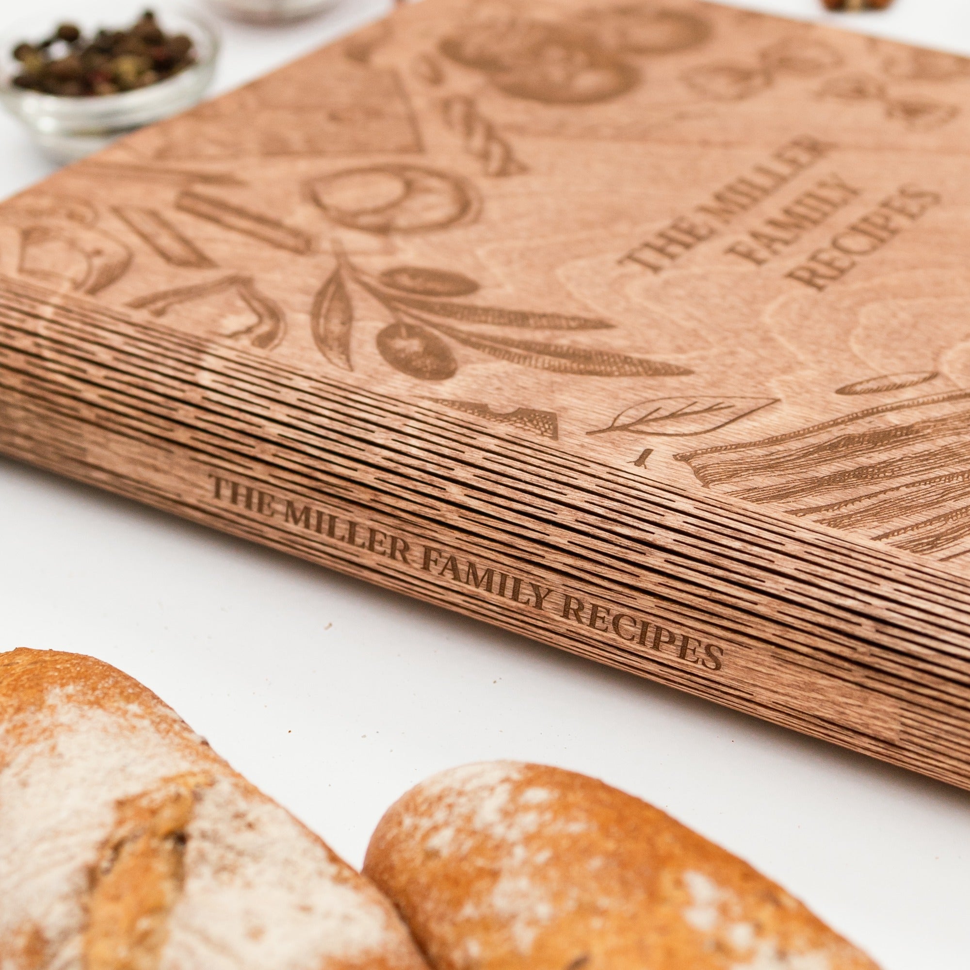 Wooden cookbook titled 'The Miller Family Recipes' with bread slices in the foreground.