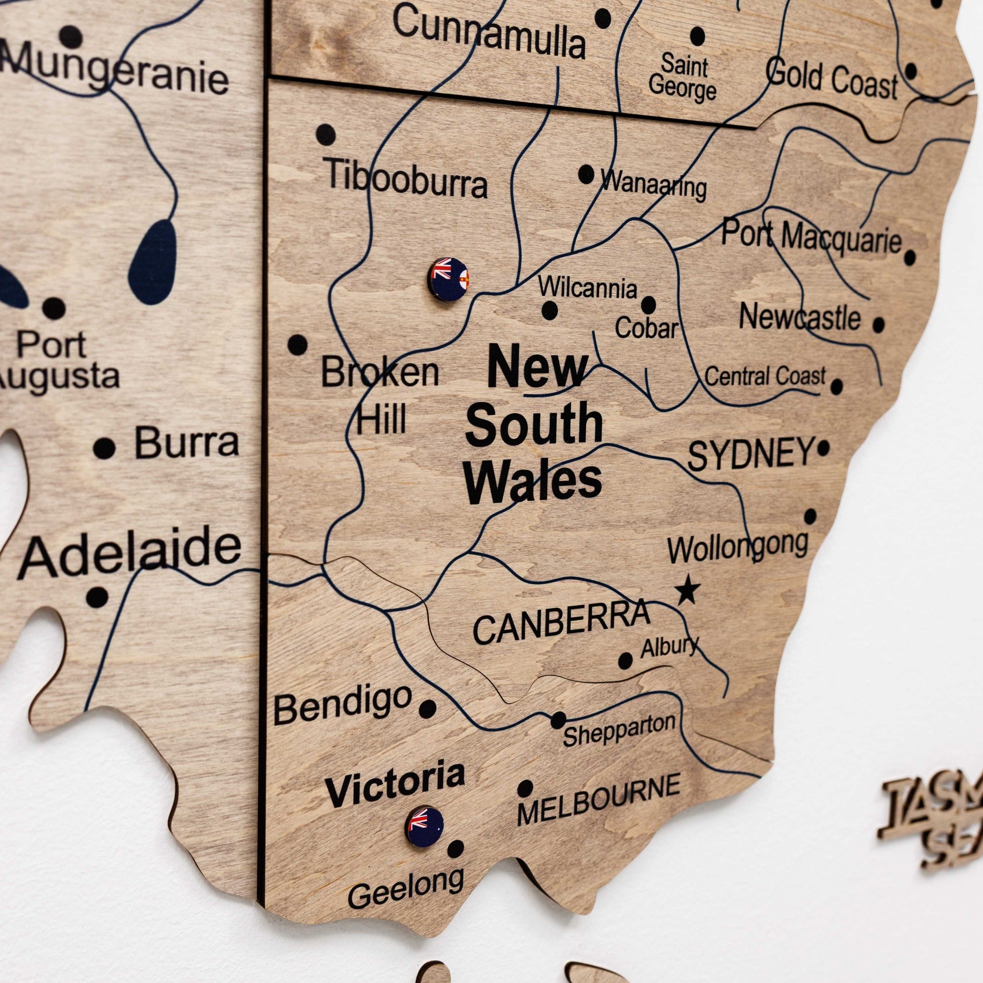 Wooden puzzle piece map of New South Wales with cities labeled