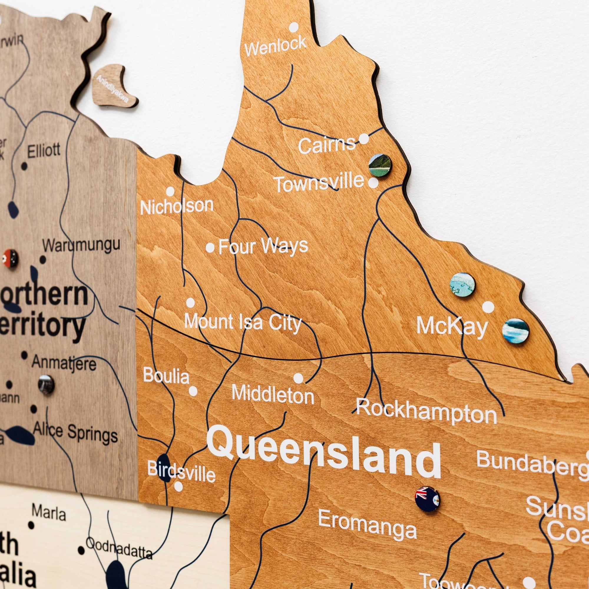 Wooden map of Queensland with pins marking locations