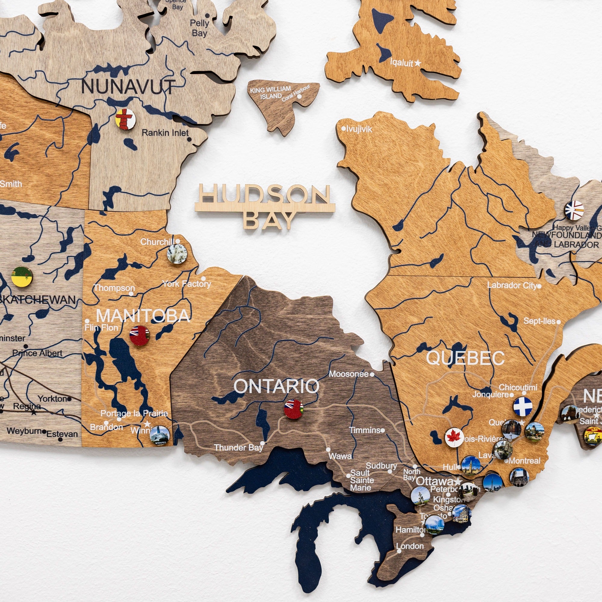 Wooden map of Canada with various regions labeled on a white background