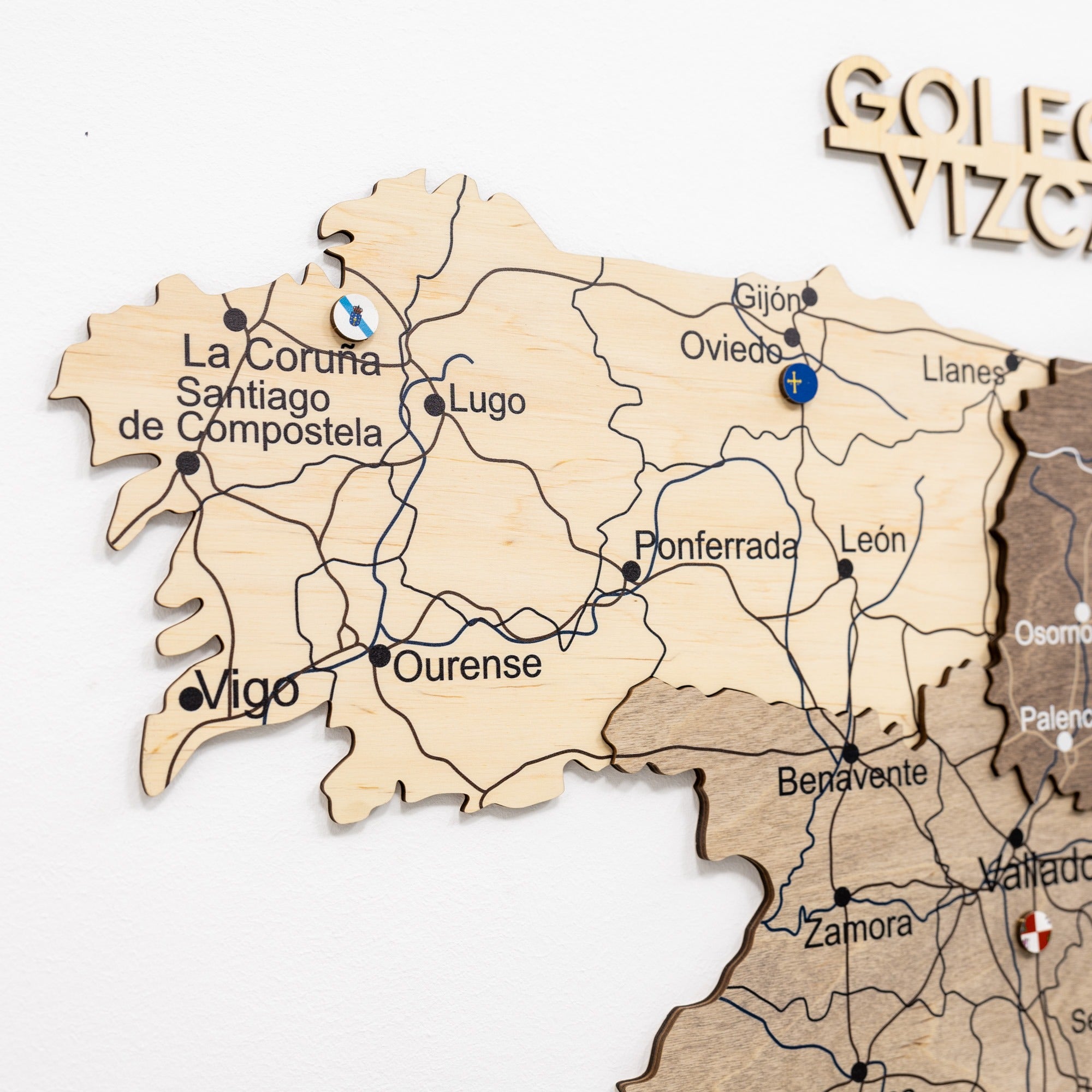 Wooden map of Galicia with labeled cities on a white background
