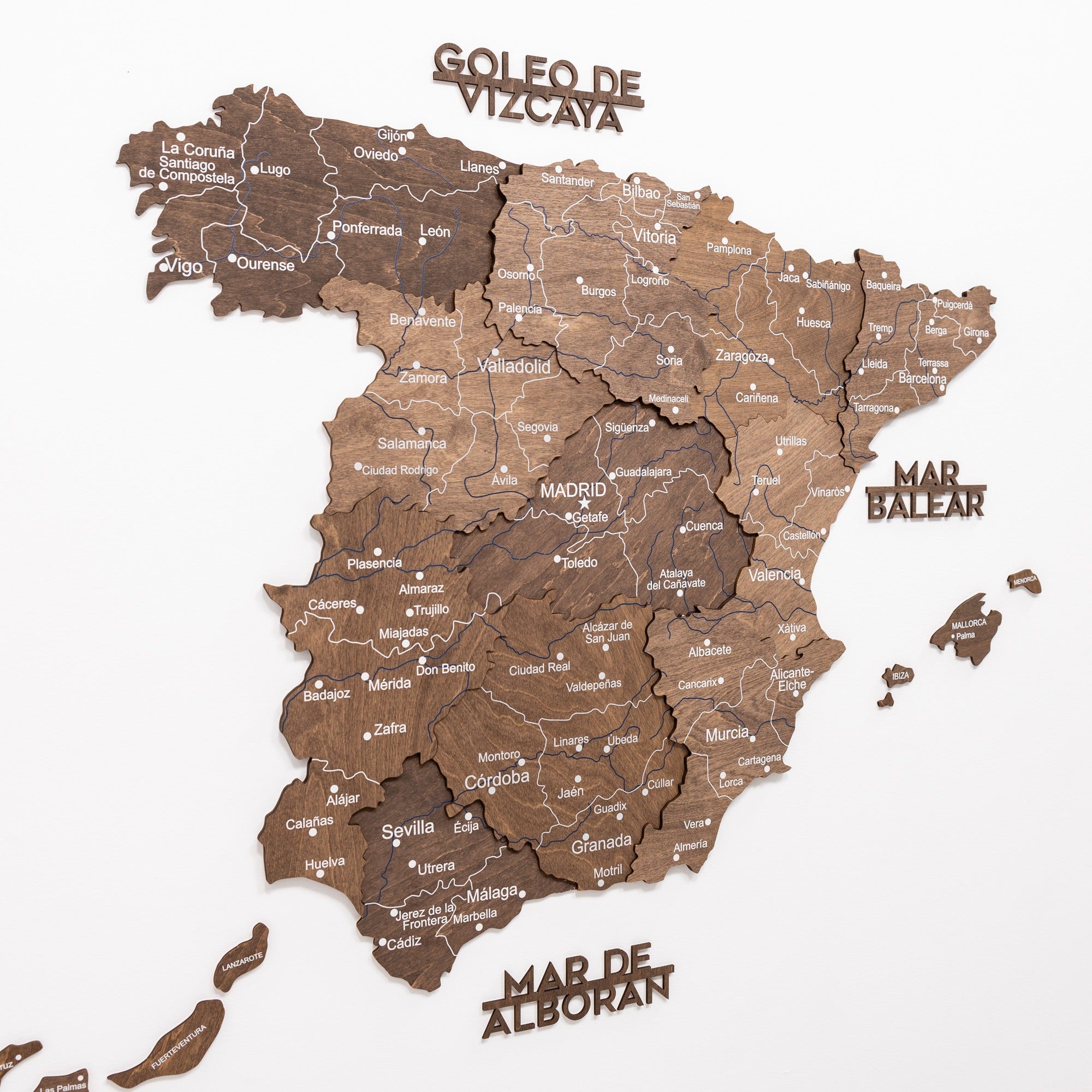Wooden map of Spain with labeled regions on a white background
