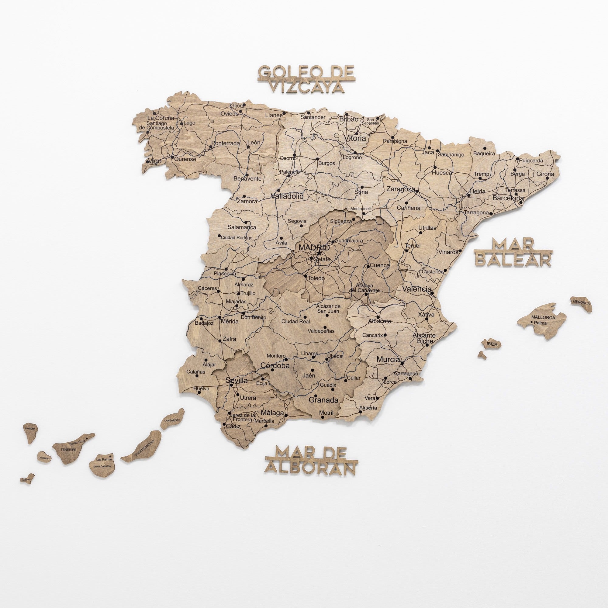 Wooden map of Spain with labeled regions on a white background