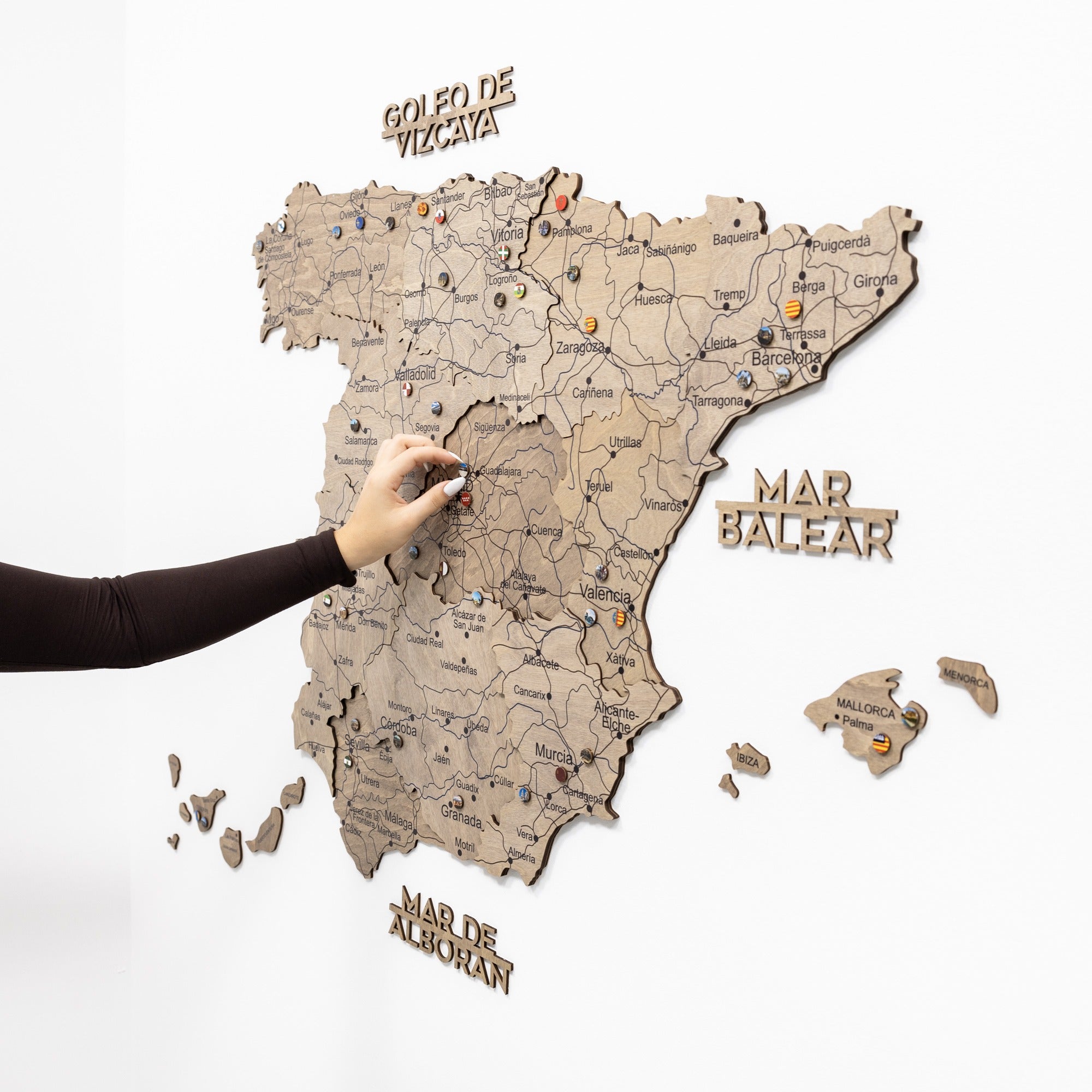 Wooden map of Spain with detachable regions on a white background