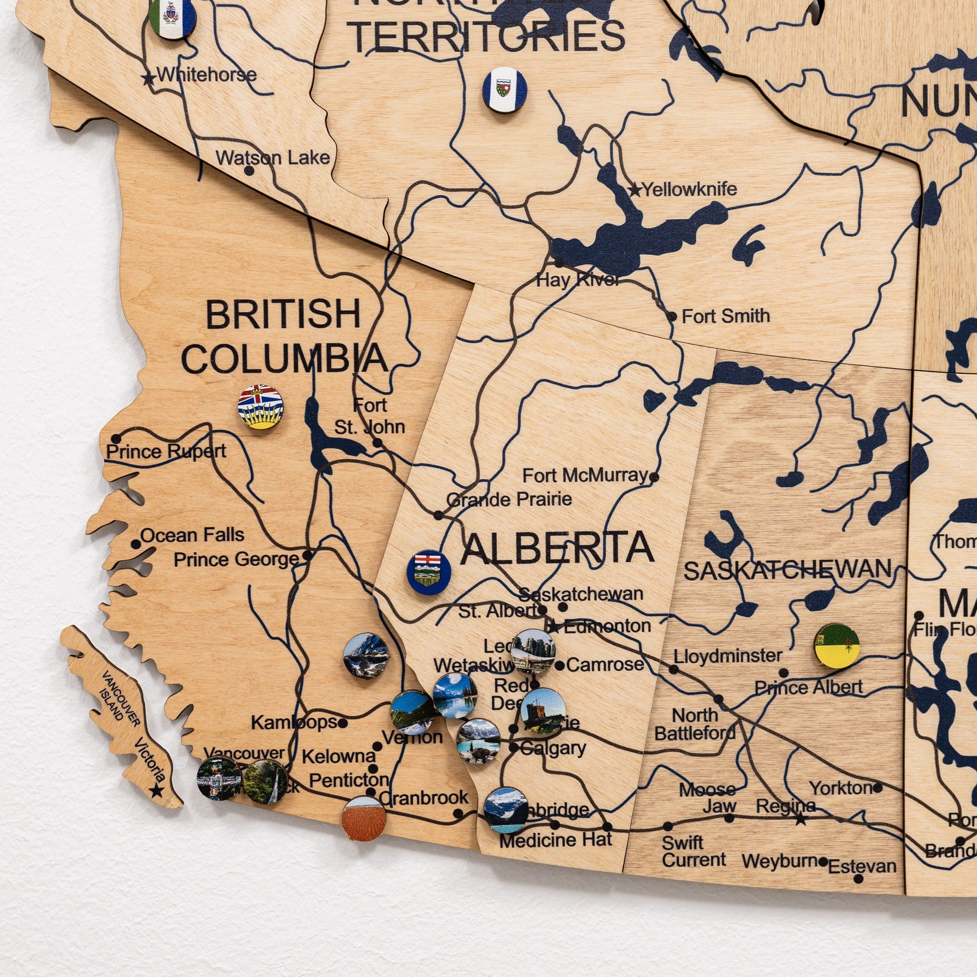 Wooden map of Canada with pins marking various locations