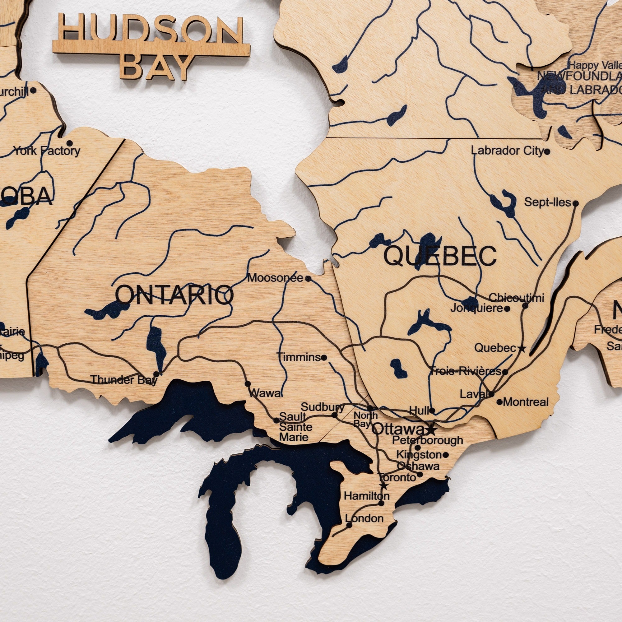 Wooden map of Canada with 'Hudson Bay' branding on a white background