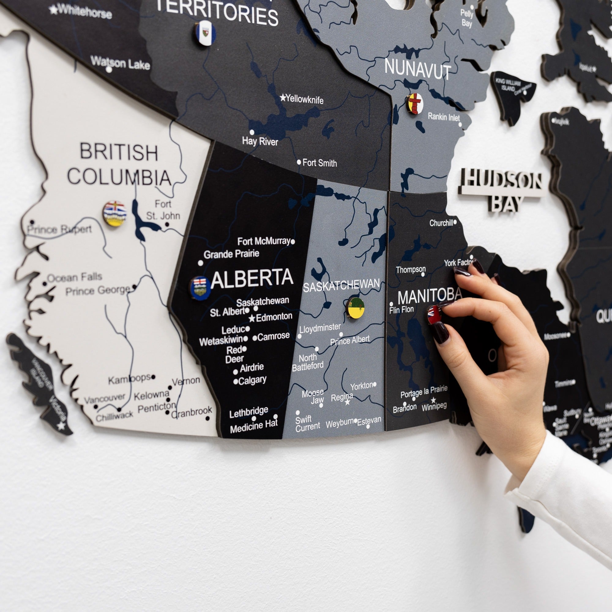 Map of Canada with a hand placing a small object on it