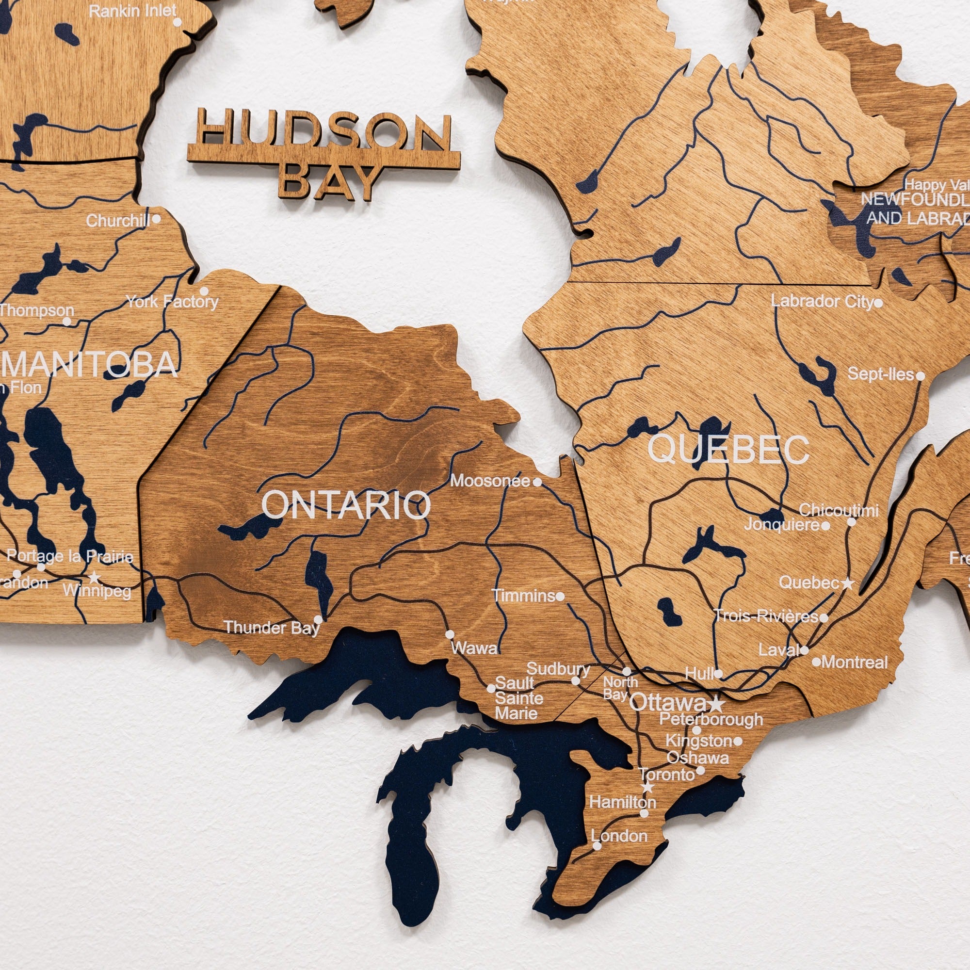 Wooden map of Canada with Hudson Bay labeled on a white background