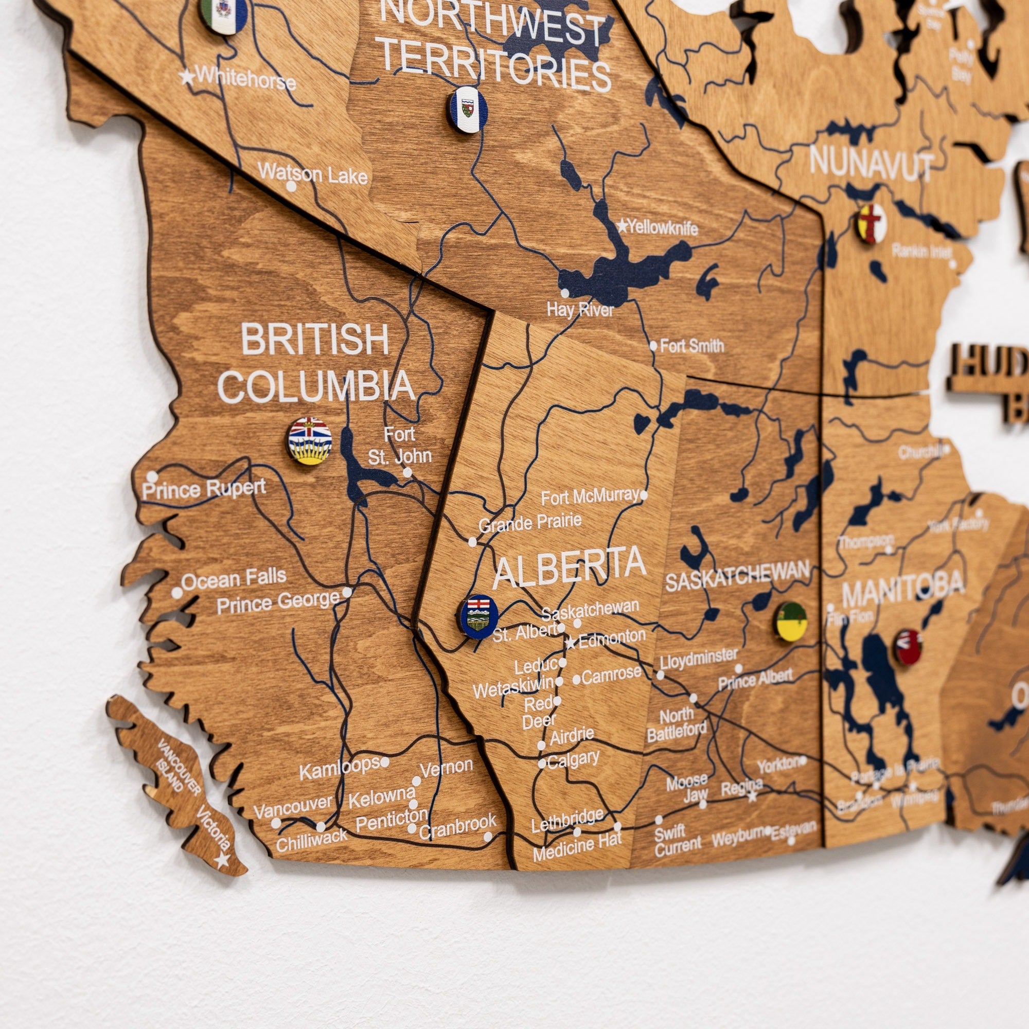 Wooden map of Canada with British Columbia, Alberta, and other provinces.