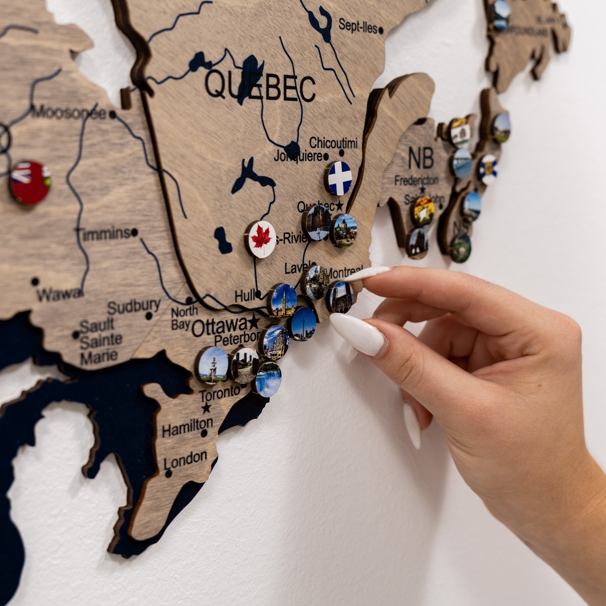 Wooden map of Canada with pins marking various locations