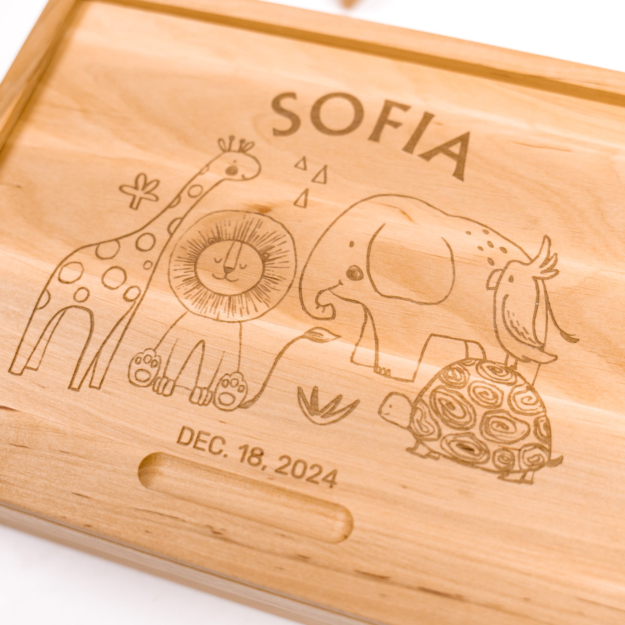 Wooden plaque with engraved animals and personalized text on a white background