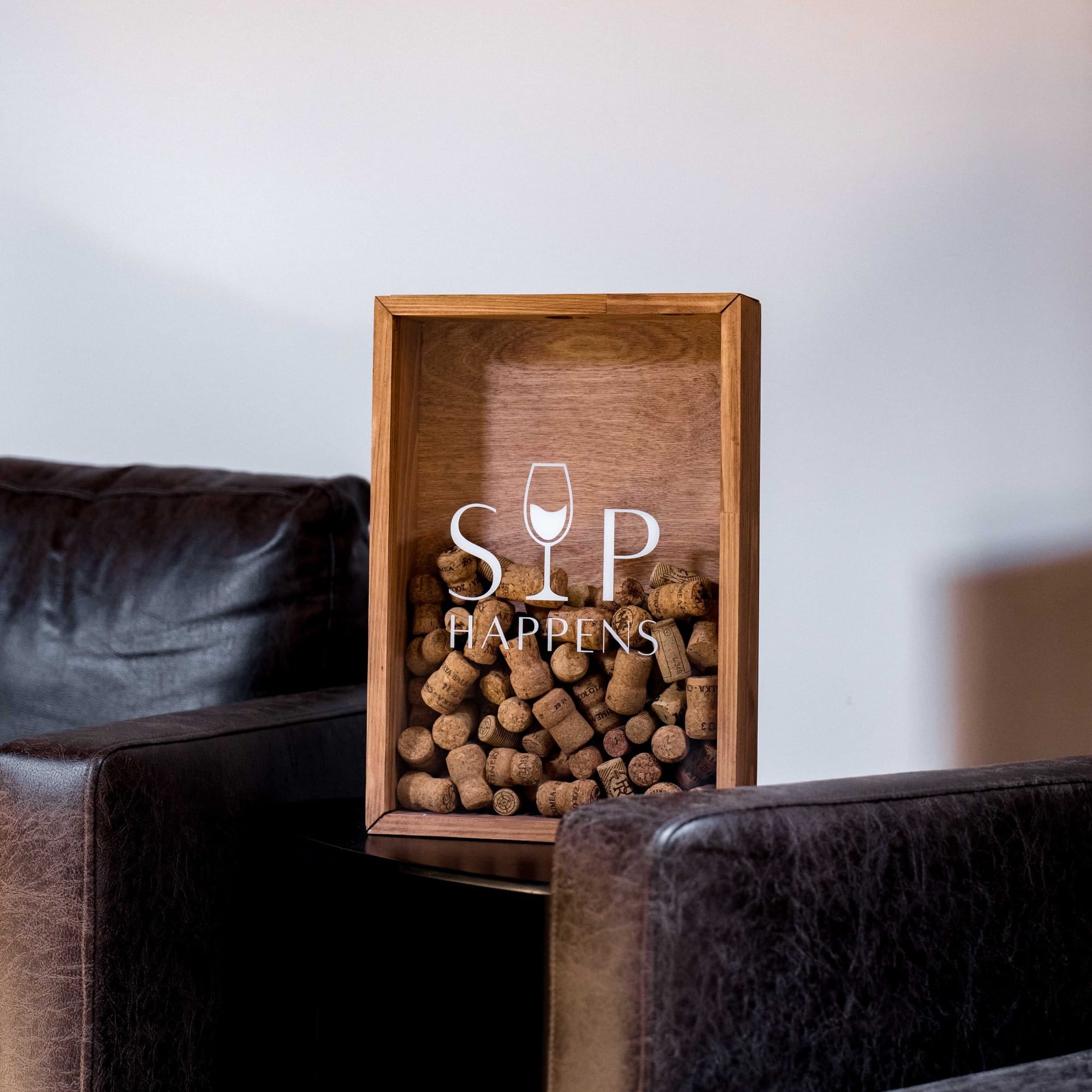 A wooden shadow box display filled with wine corks