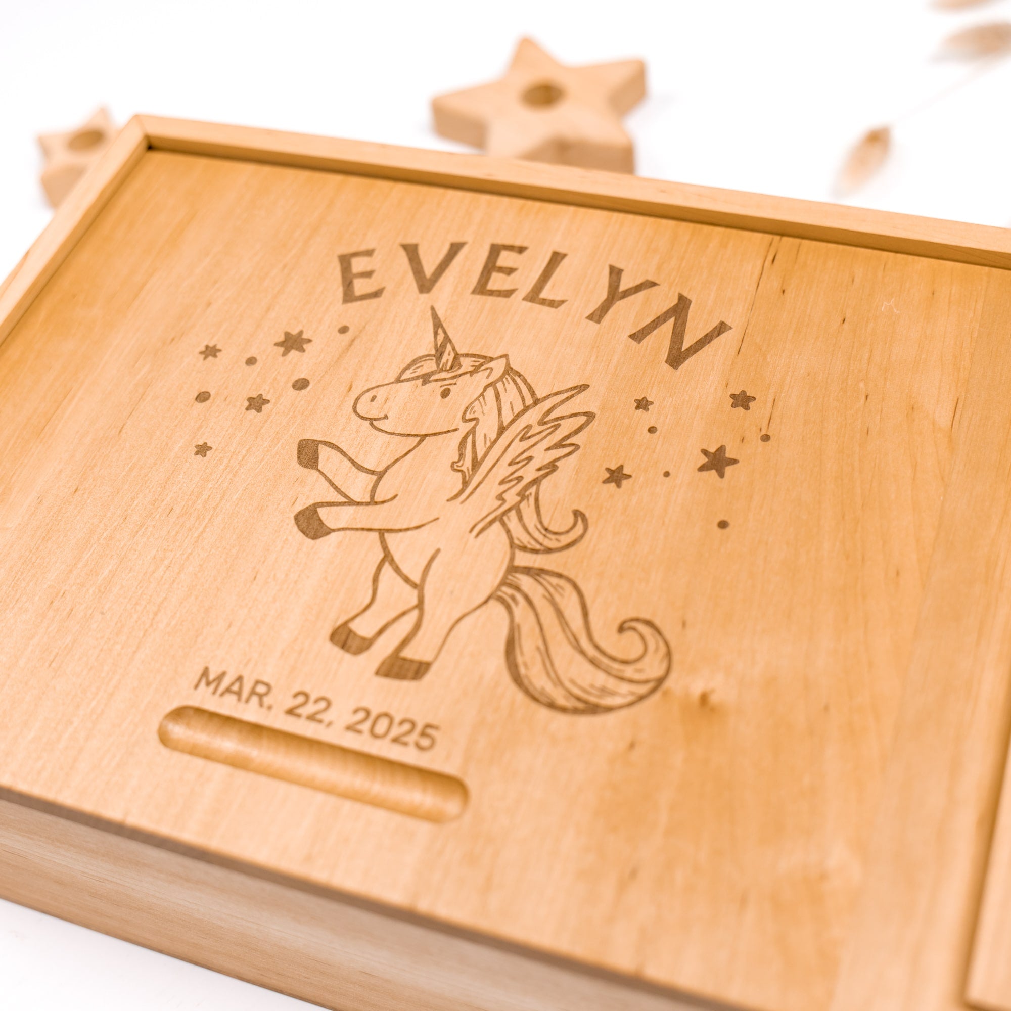 Wooden box with engraved unicorn design and name 'Evelyn' on a white background