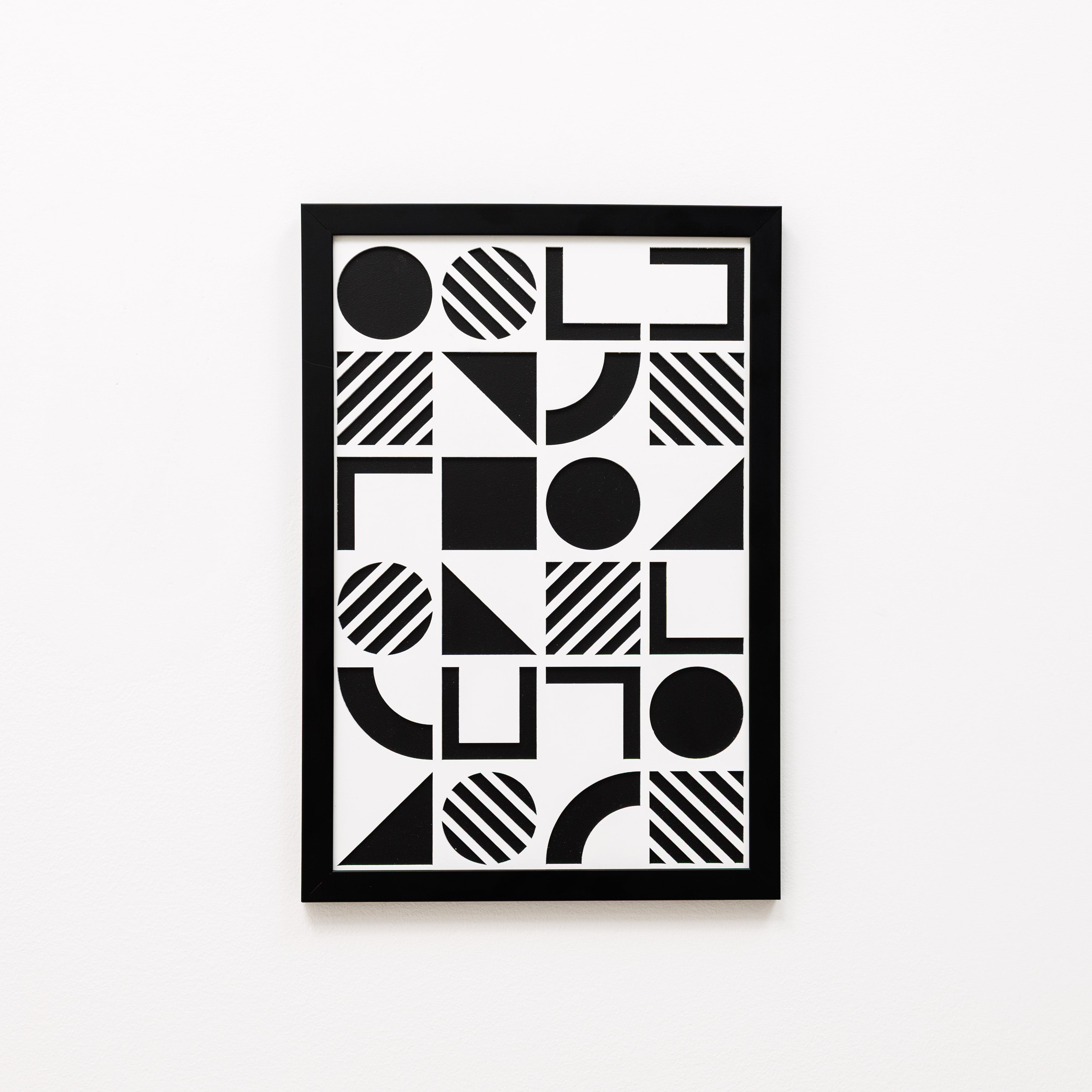 Framed black and white geometric art print on a white background