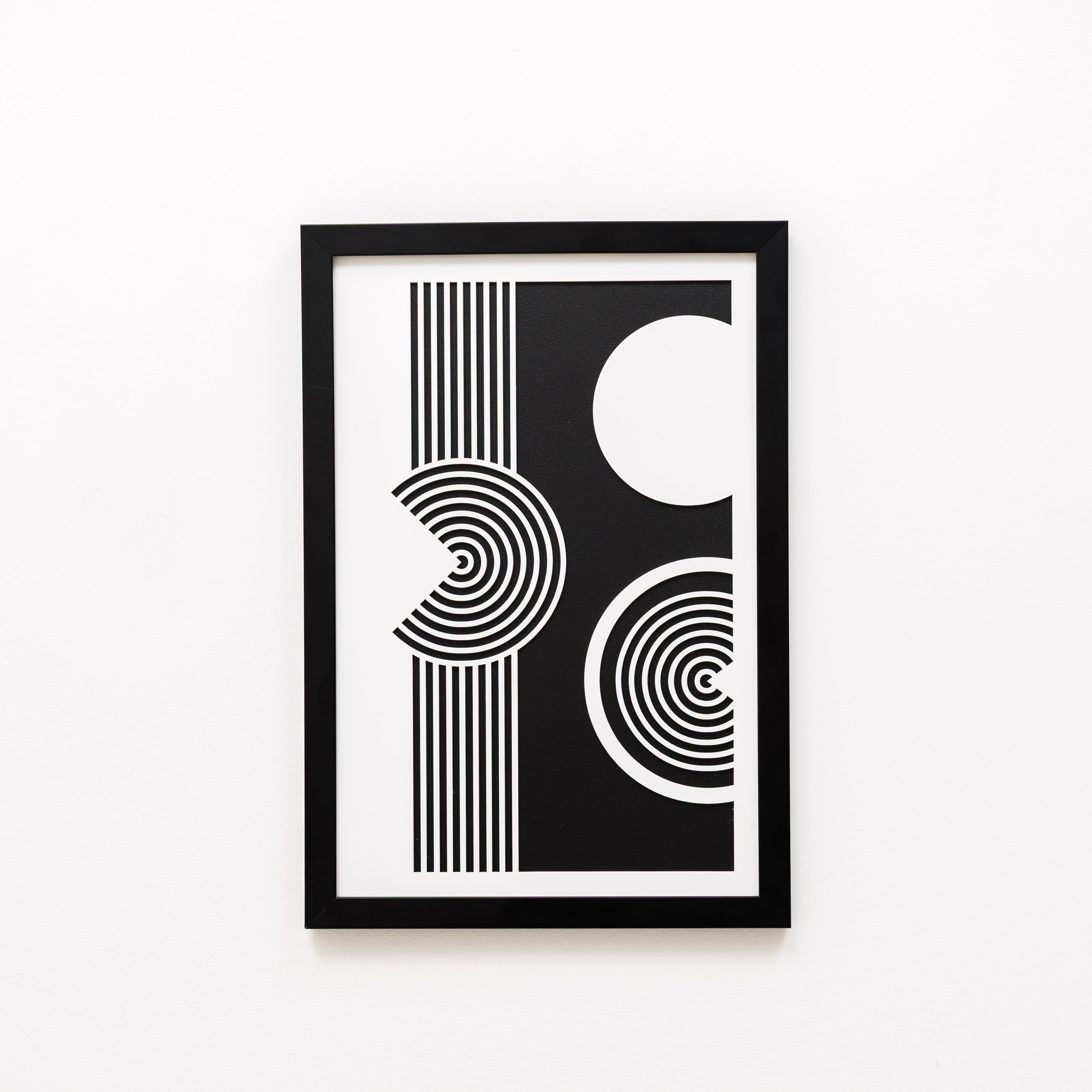 Framed black and white abstract art print on a white background