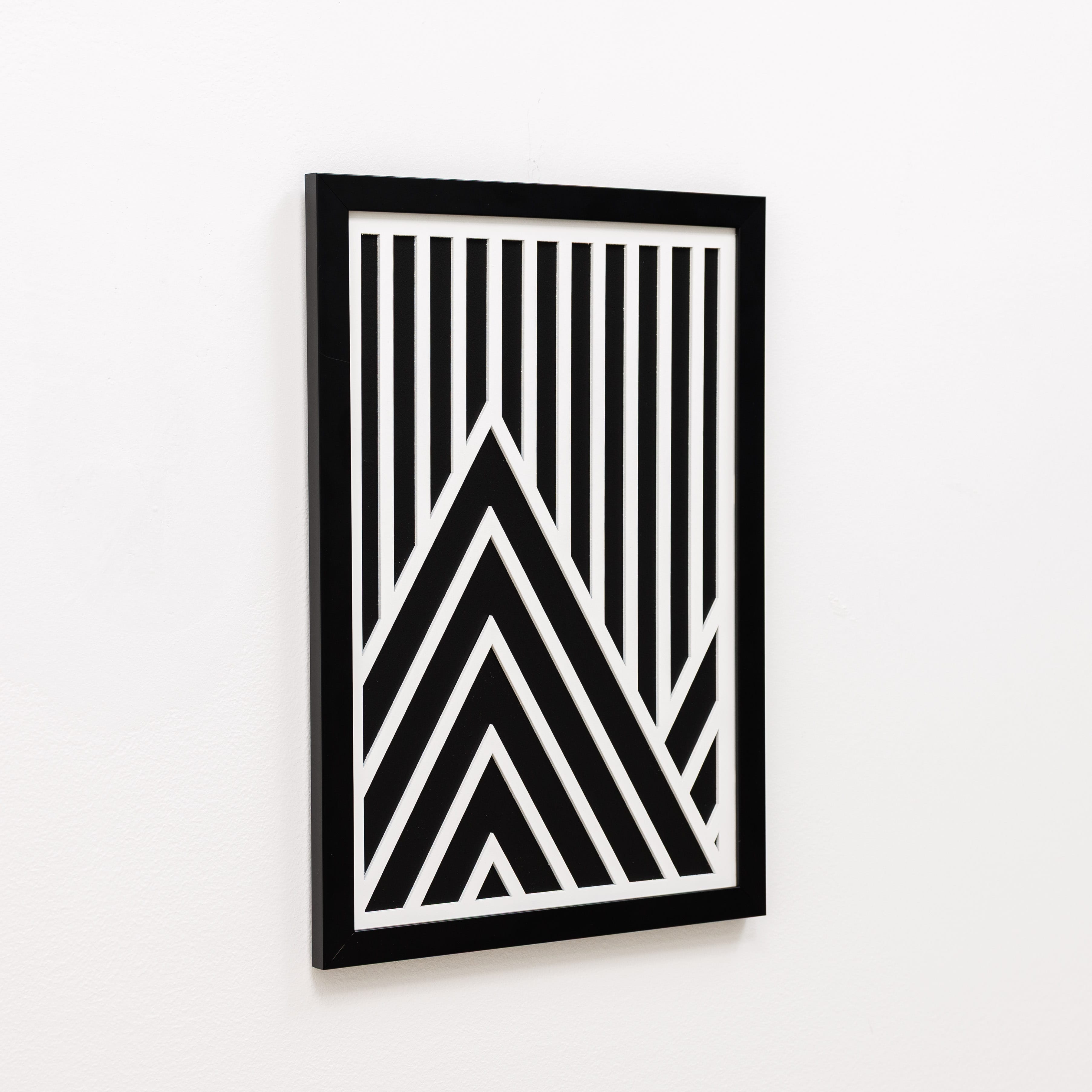 Framed black and white geometric art on a white background