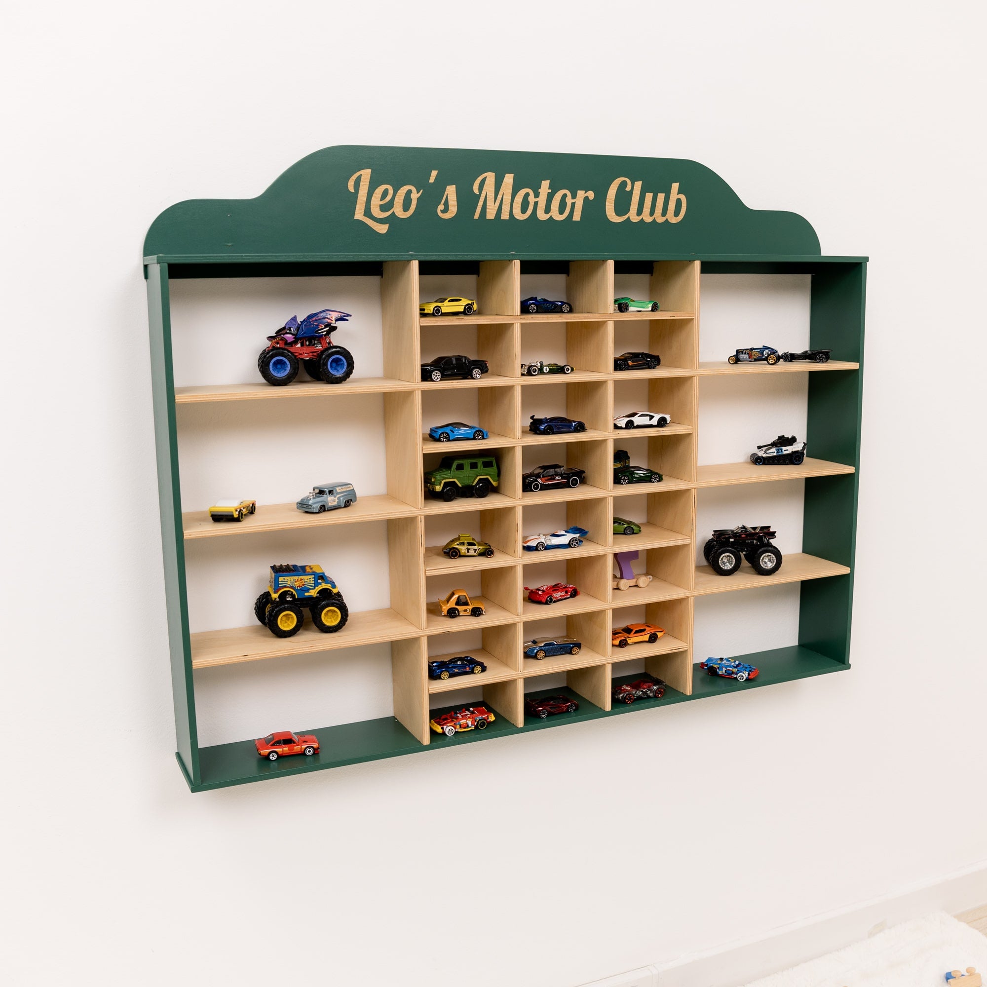 Wooden shelf with toy cars labeled 'Leo's Motor Club' on a white background