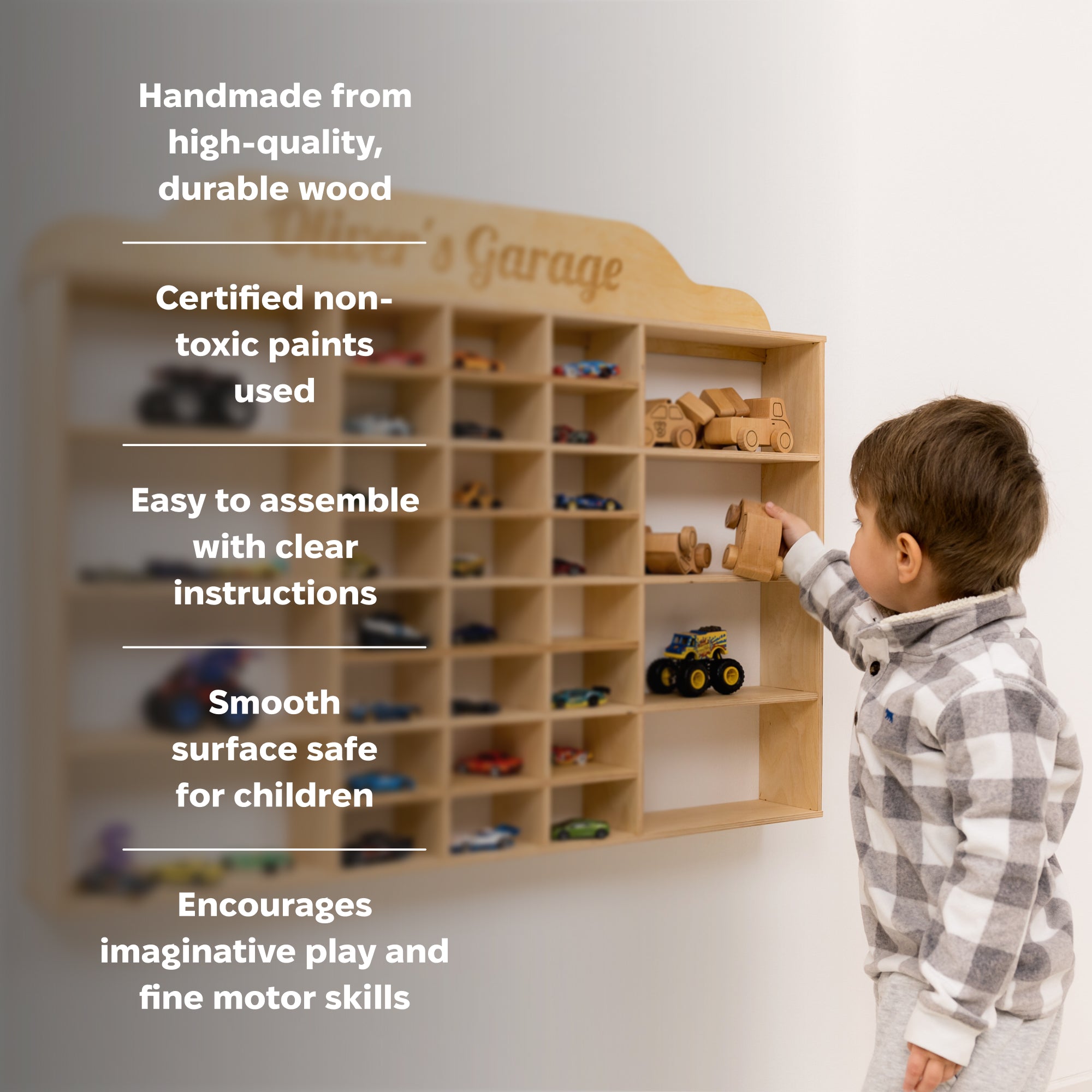 Wooden toy car display shelf with 'Oliver's Garage' on a white wall