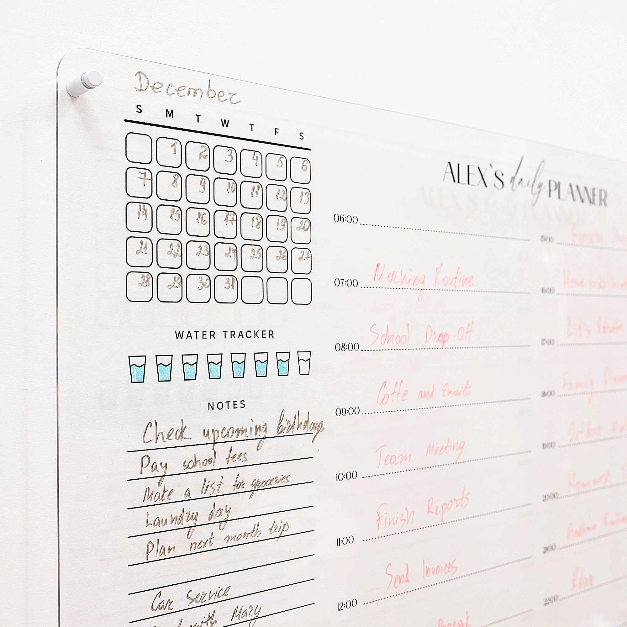 Daily planner with calendar, water tracker, and notes section on a whiteboard.