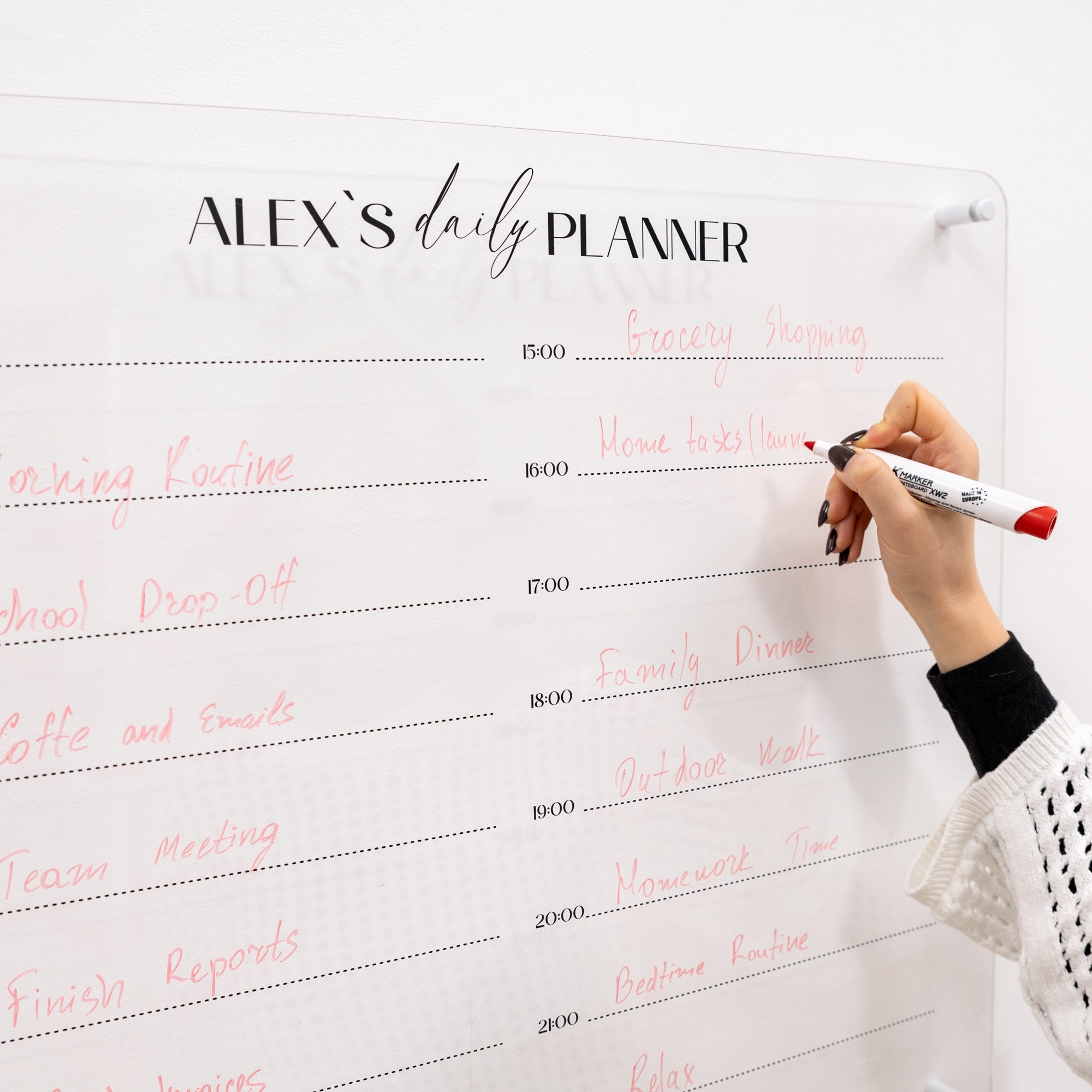 Person writing on a planner with 'Alex's daily Planner' at the top.