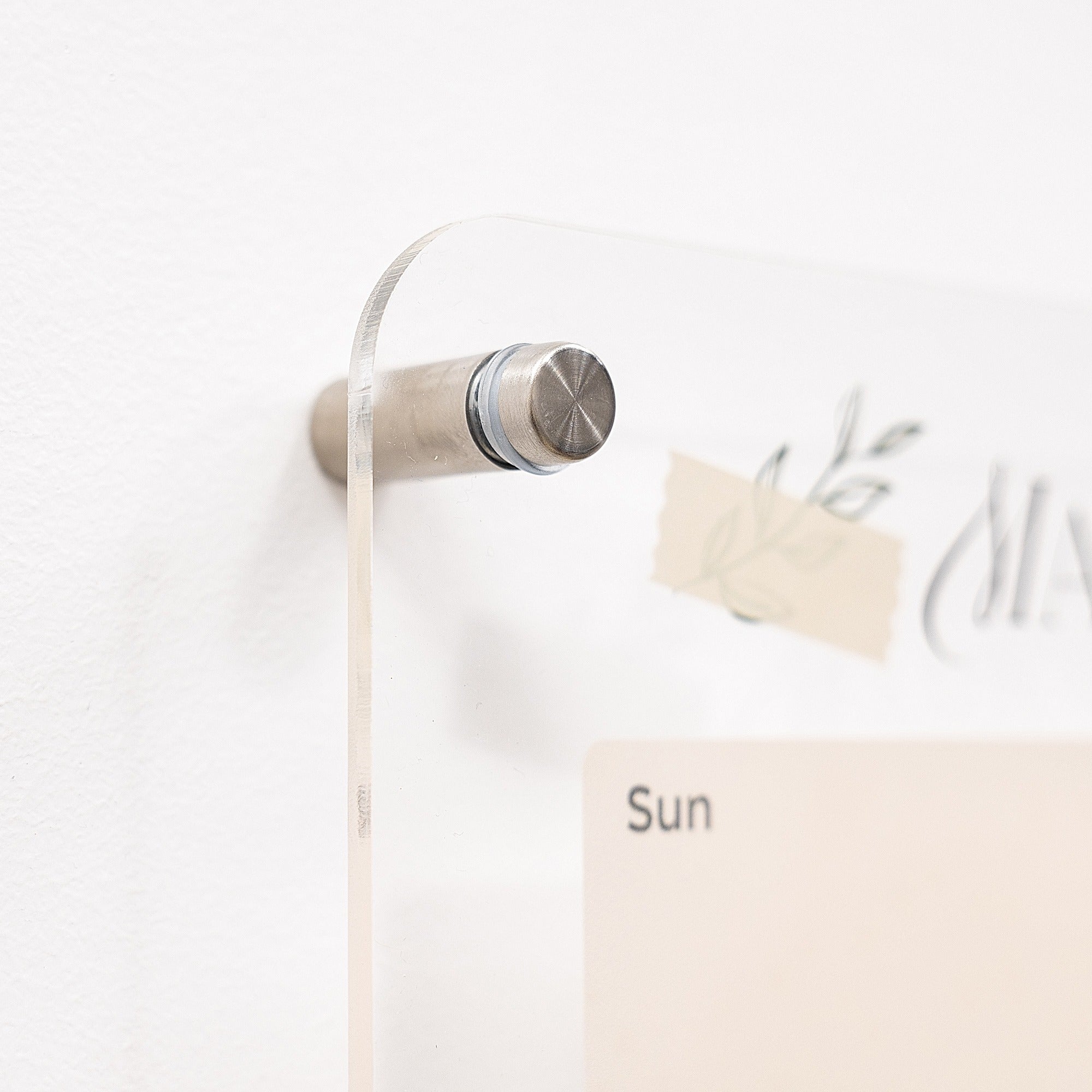 Calendar with a metallic pen holder on a white wall