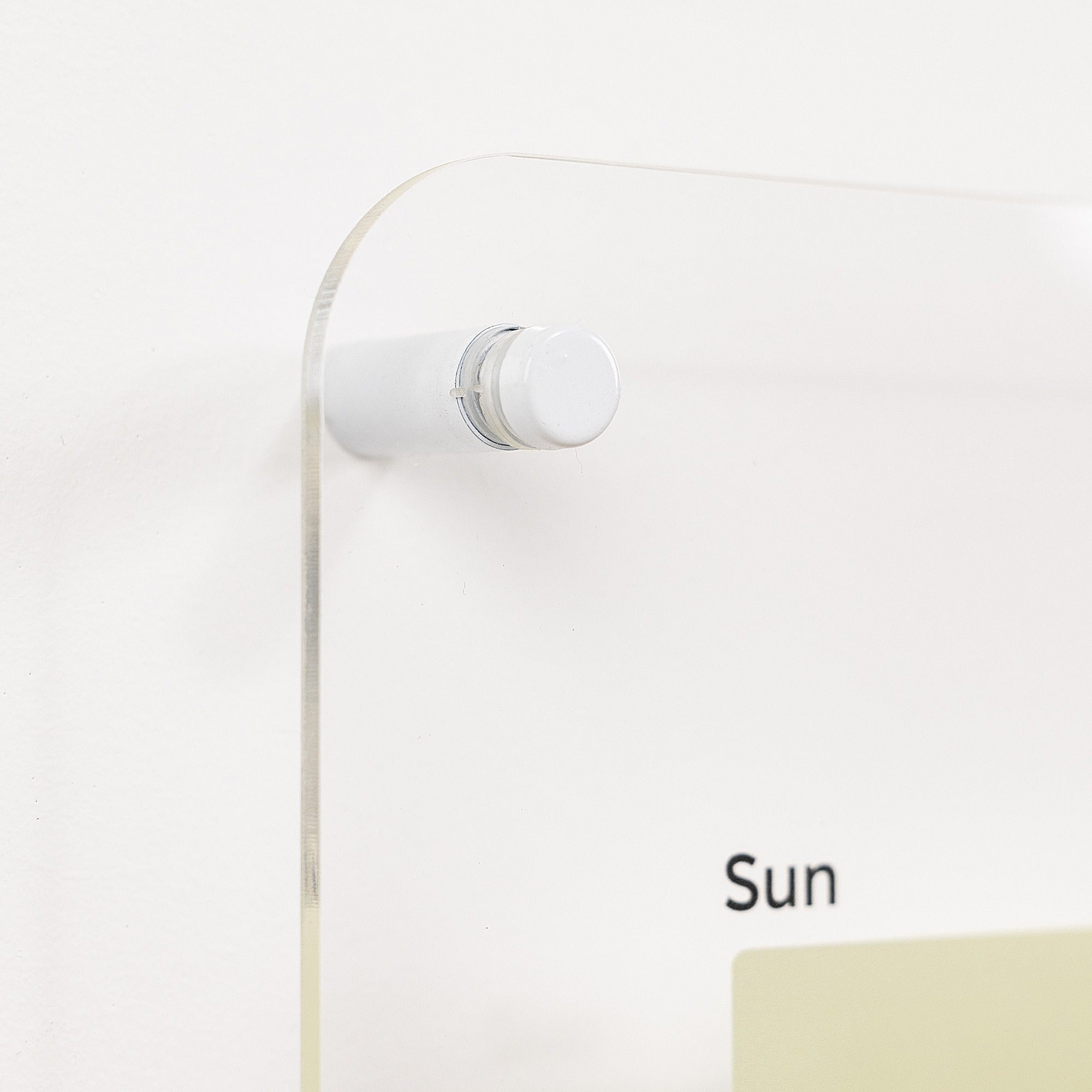 White wall-mounted lamp with a cord on a light gray background