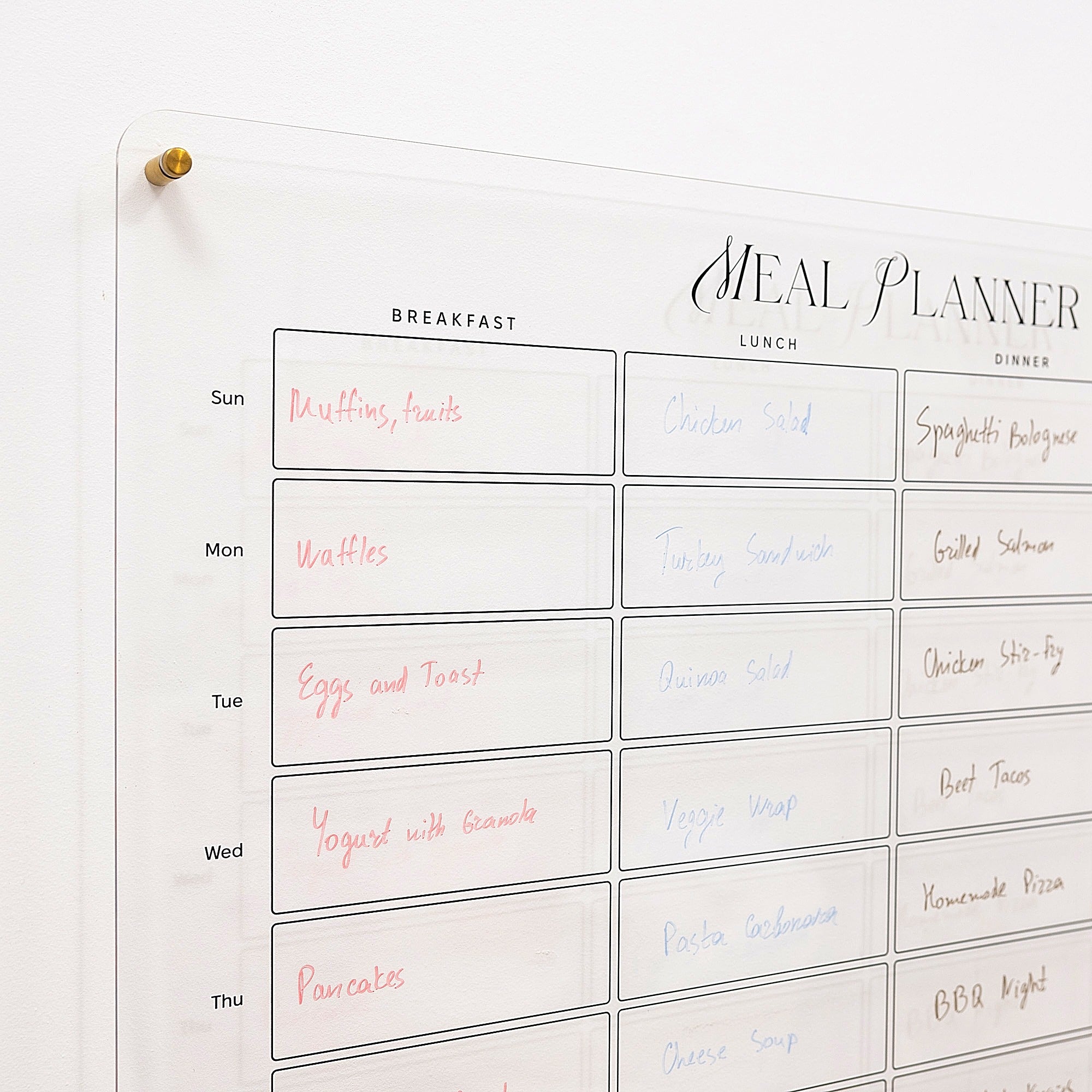 Meal planner with handwritten meals for each day of the week on a whiteboard.