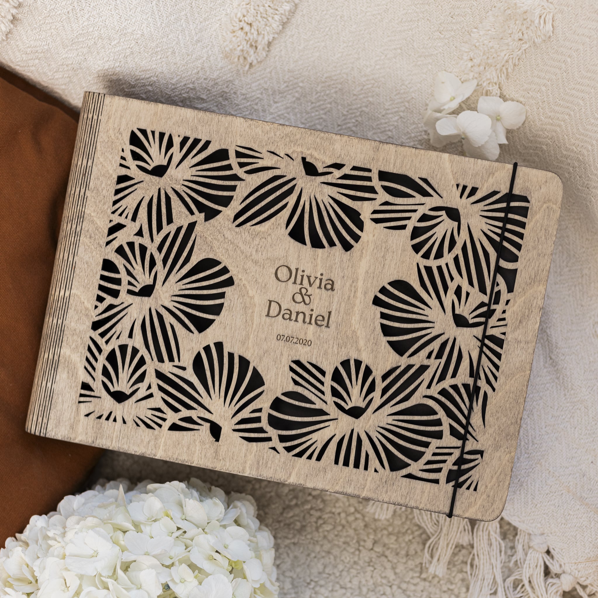 Personalized wooden box with butterfly design and engraved names on a soft fabric background