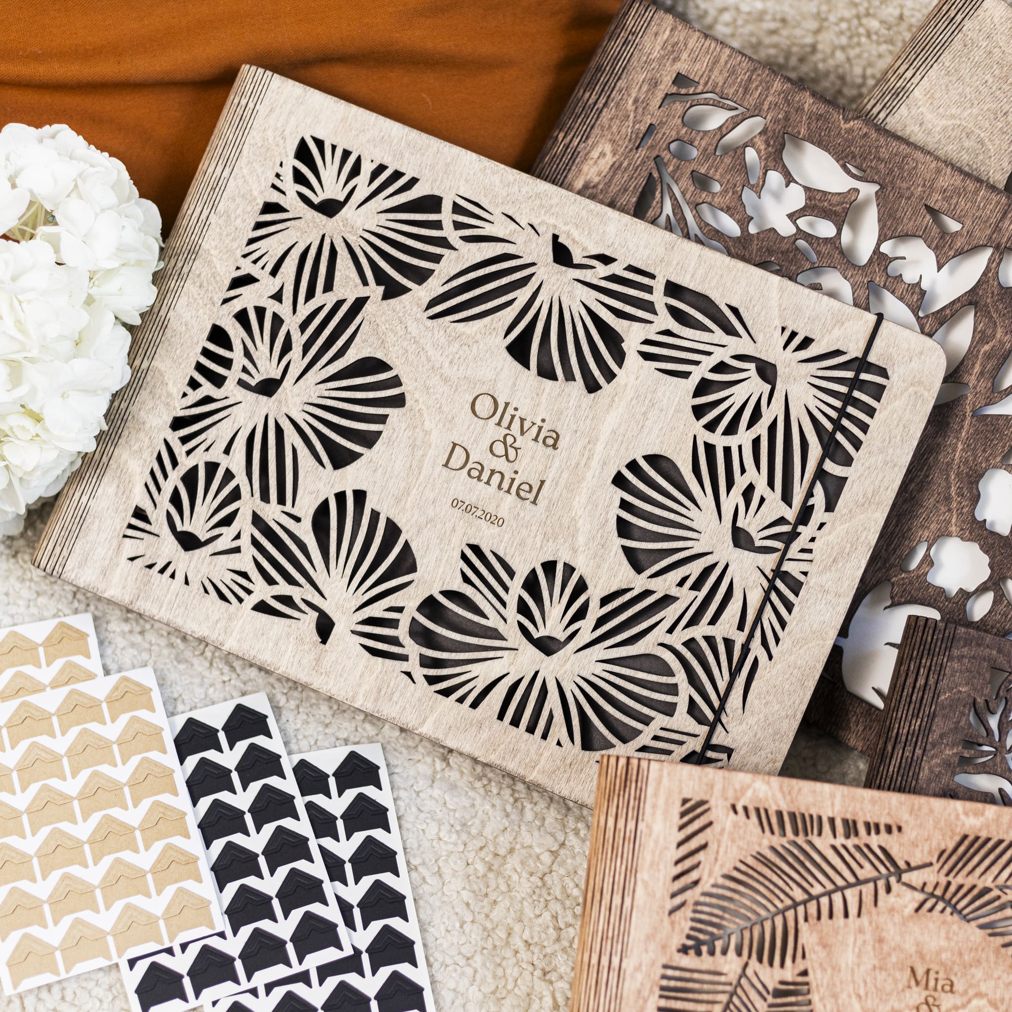 Personalized stencils with floral patterns and names on a textured surface.