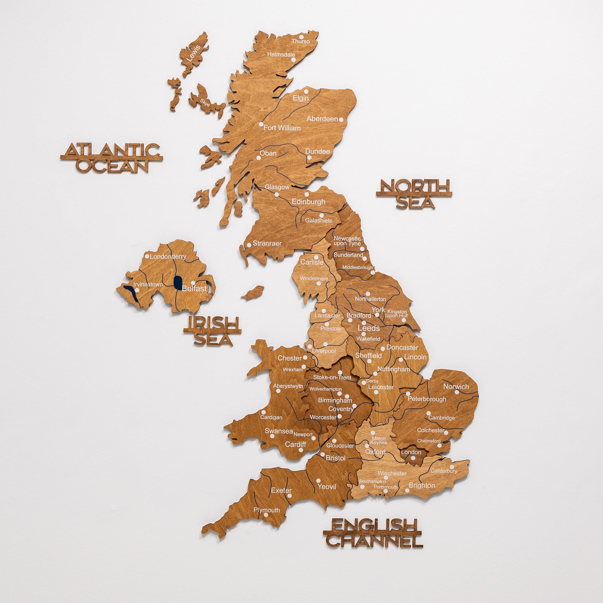 Wooden map of the United Kingdom with labeled seas and countries on a white background
