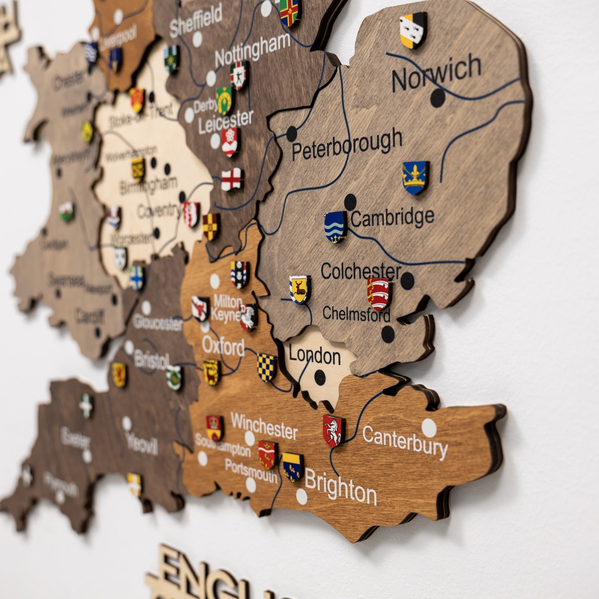 Wooden map of England with cities and flags on a white background