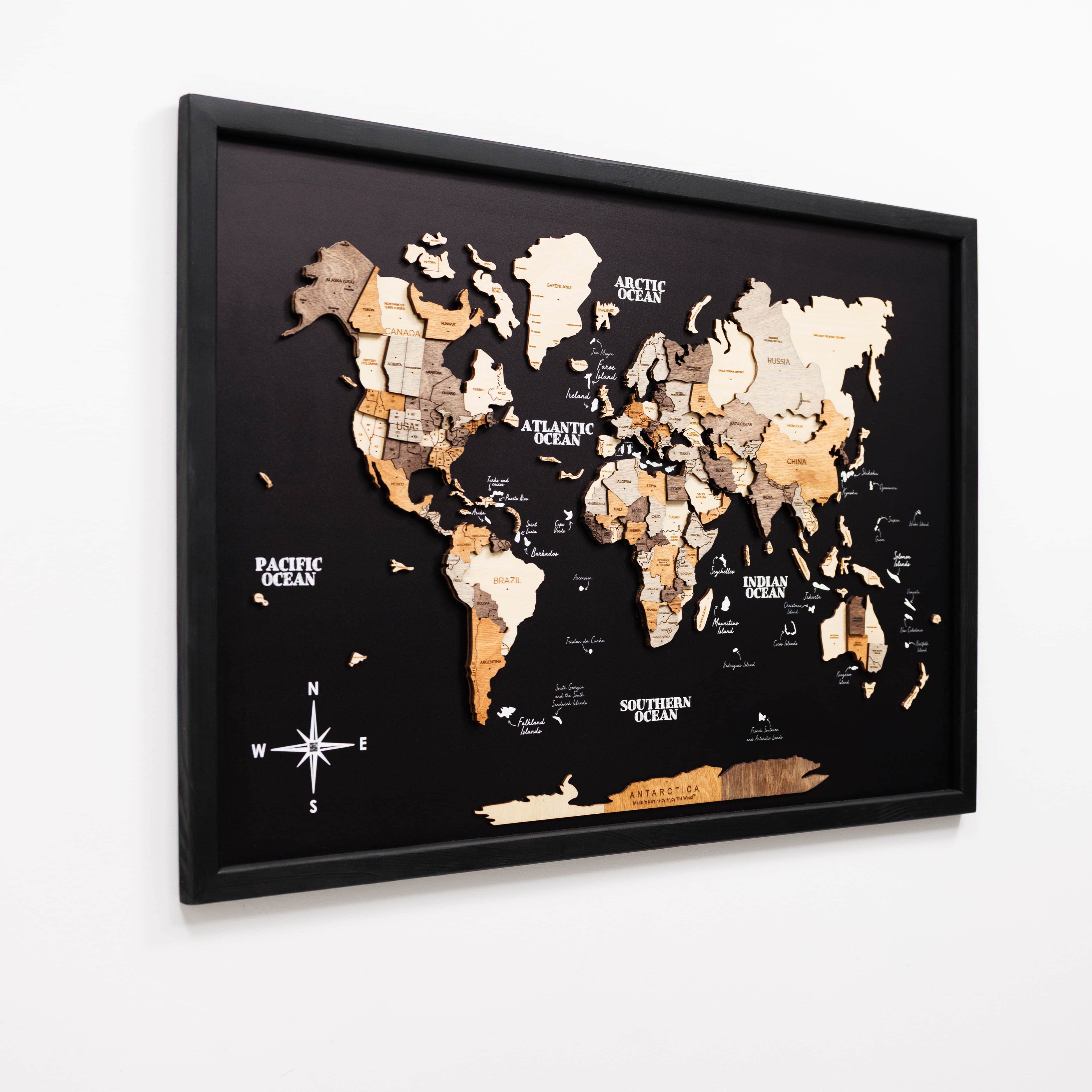 World map with wooden textures in a black frame on a white background