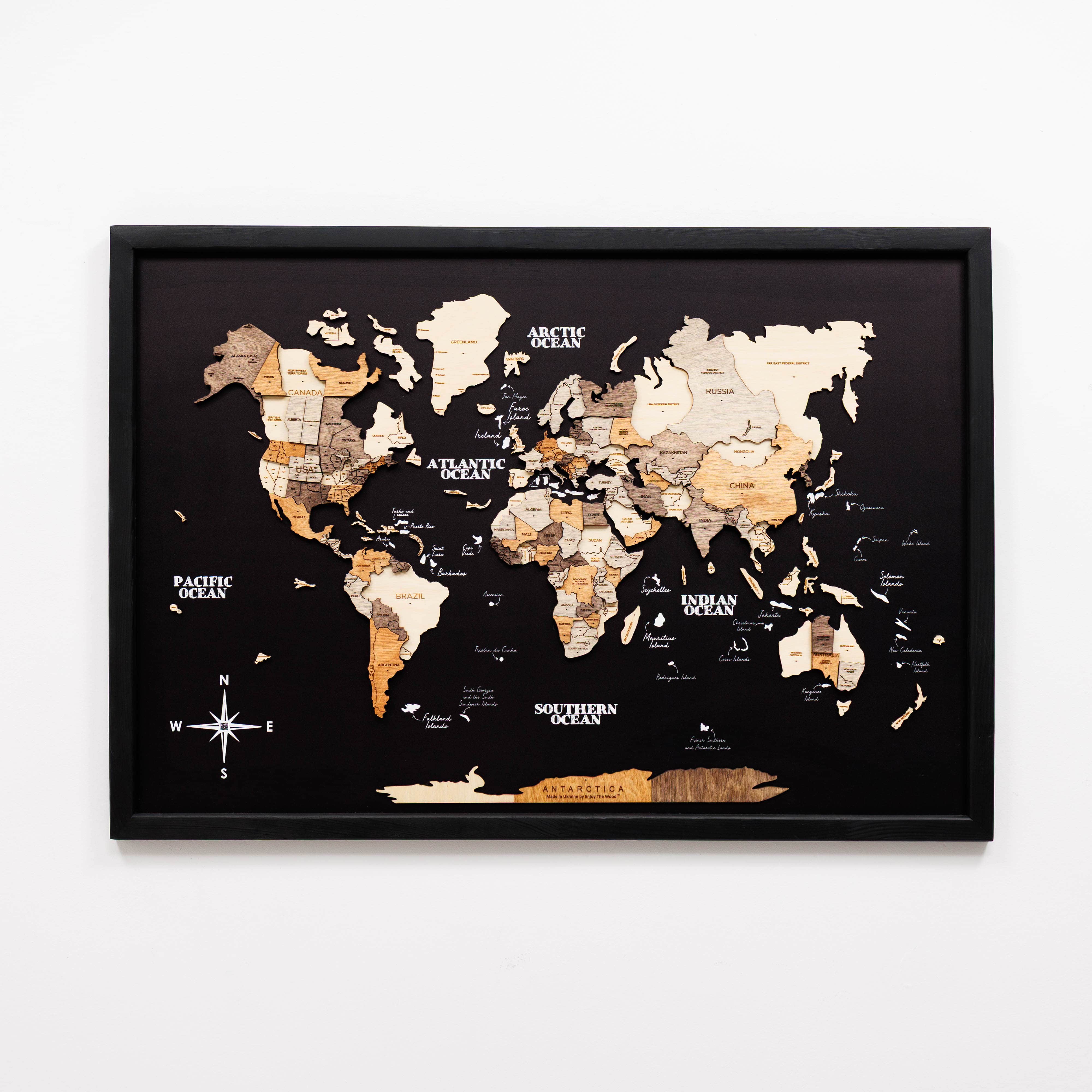 World map with wooden texture in a black frame on a white background