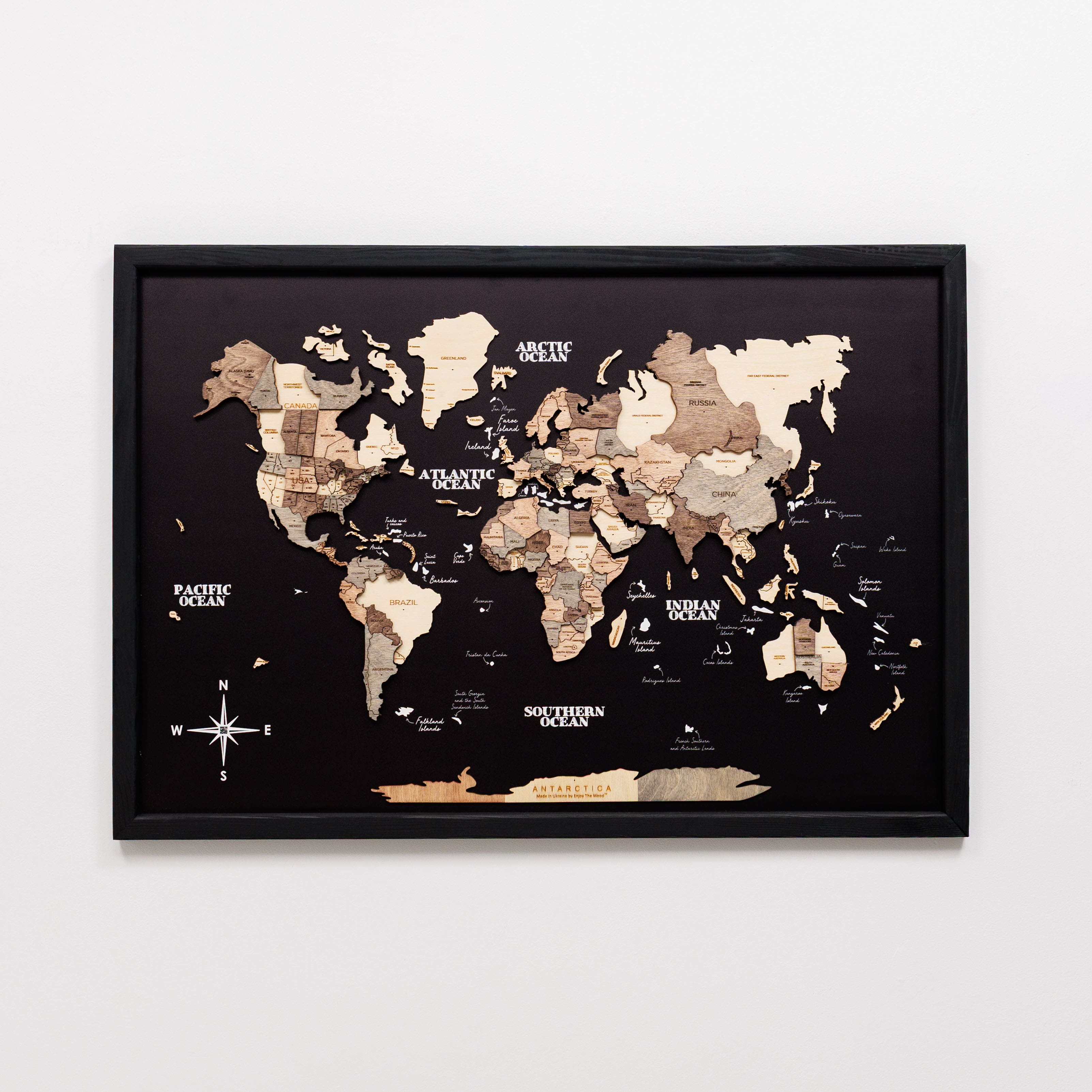Framed world map with wooden texture on a white background