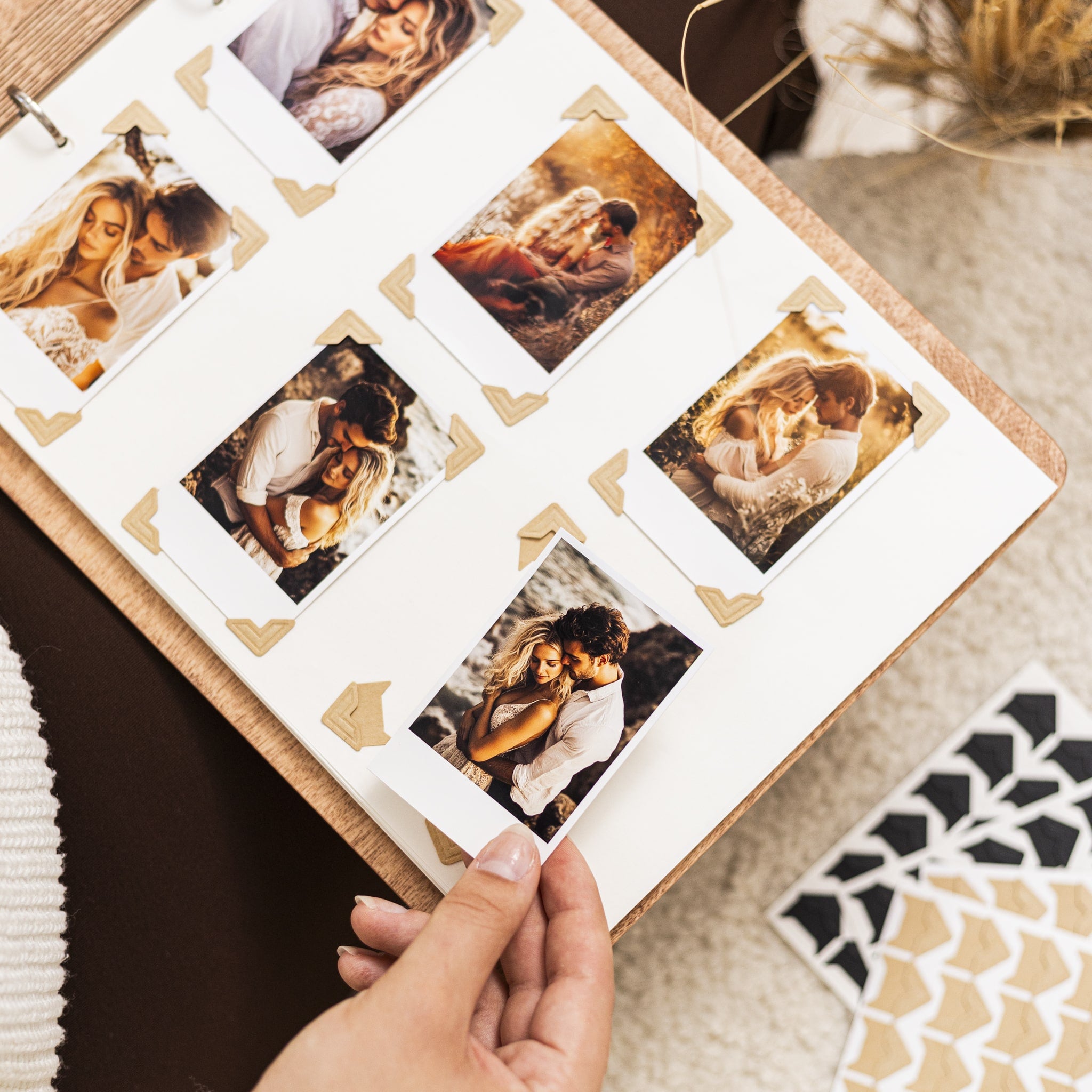 Album with Polaroid-style photos of a couple on a patterned surface