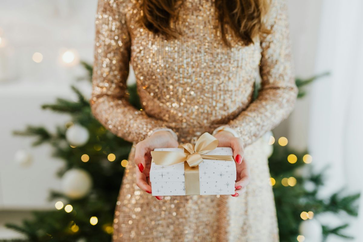 A woman holding a Christmas gift