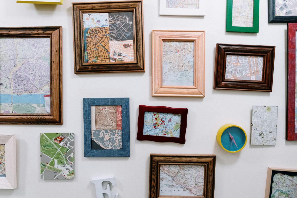 Variety of maps in wooden frames hanging on wall